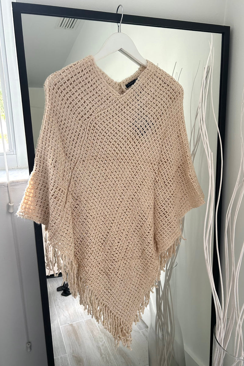 Add a touch of sparkle to your wardrobe with our Full Moon Lurex Poncho! This sequined, stretchy knit top adds just the right amount of glitz to any outfit. Plus, its fringed hem adds playful movement. Choose from two colors: black and khaki.