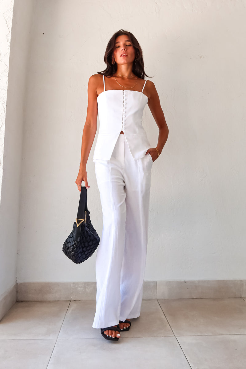 Transform your wardrobe with our DAY TO NIGHT LINEN PANT SET! This white set features a pleated tank top with adjustable shoulder straps and a front button closure, paired with non-stretch pants that have a zipper button closure and convenient front pockets. Perfect for any occasion, top lined and bottom non-lined for added comfort and style.