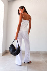 Transform your wardrobe with our DAY TO NIGHT LINEN PANT SET! This white set features a pleated tank top with adjustable shoulder straps and a front button closure, paired with non-stretch pants that have a zipper button closure and convenient front pockets. Perfect for any occasion, top lined and bottom non-lined for added comfort and style.