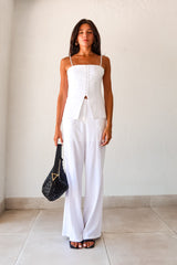 Transform your wardrobe with our DAY TO NIGHT LINEN PANT SET! This white set features a pleated tank top with adjustable shoulder straps and a front button closure, paired with non-stretch pants that have a zipper button closure and convenient front pockets. Perfect for any occasion, top lined and bottom non-lined for added comfort and style.