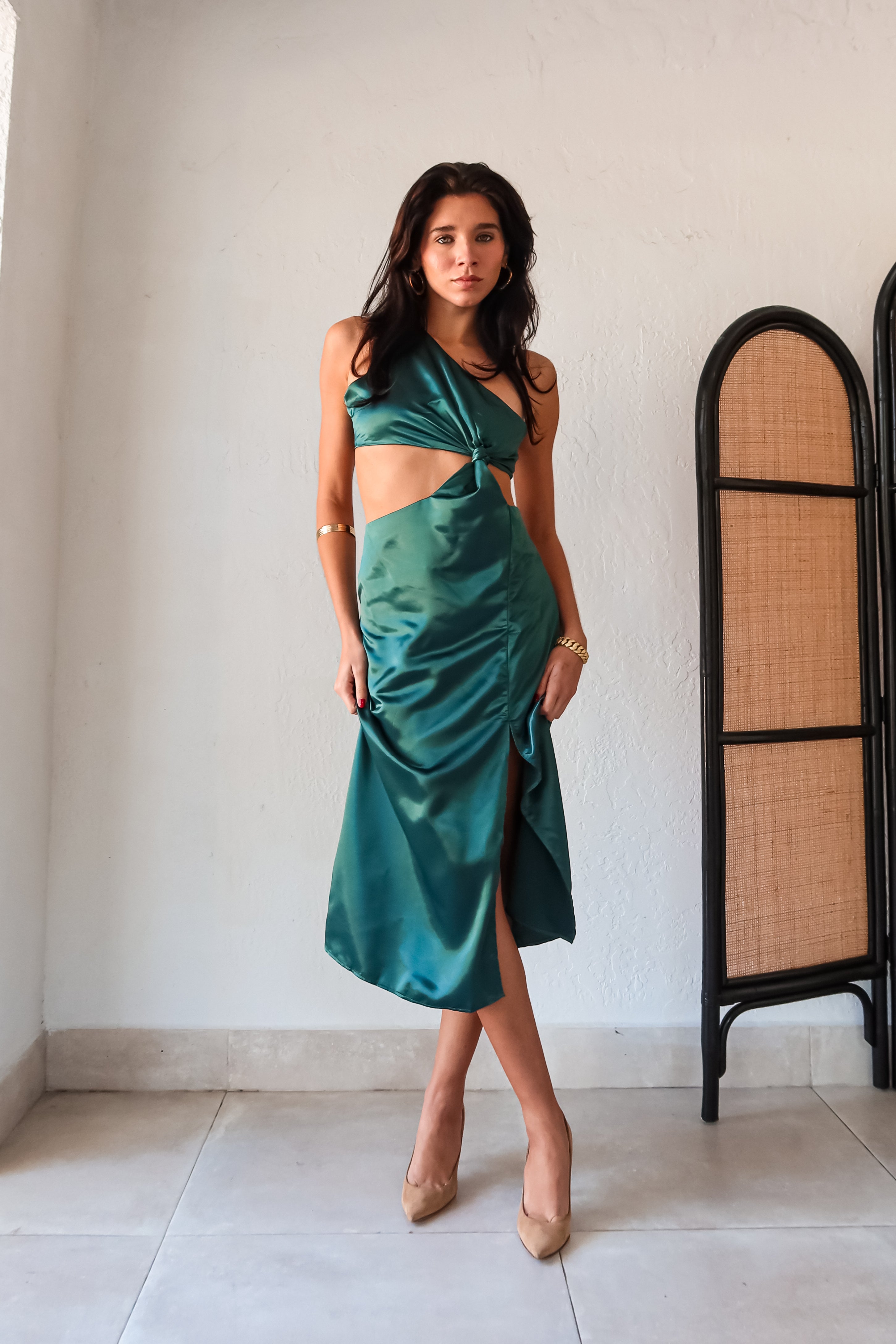 Get ready to slay at cocktail hour with this jewel green satin maxi dress! The one shoulder top with a knot detail adds a touch of glamour, while the left leg slit shows off your killer legs. Ties around back keep the look secure, and a bottom zipper closure makes getting dressed a breeze.