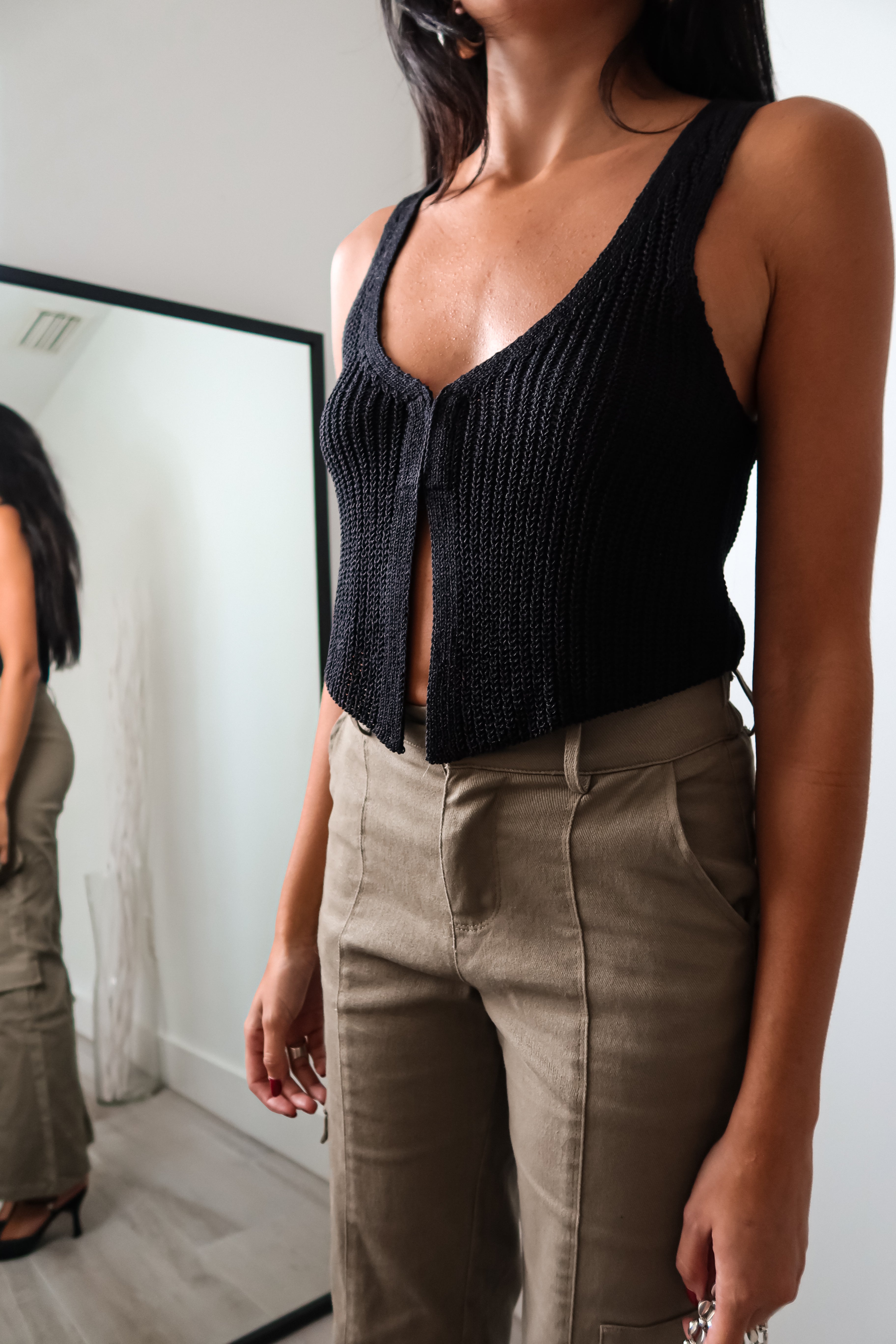 The EASTSIDE KNIT VEST TOP is a must-have tank top for any fashion-forward wardrobe. Made from a luxurious and stretchy knit material, this tank features a split front design with a hook closure for added style. It's no surprise that this top is a best seller - perfect for any occasion!