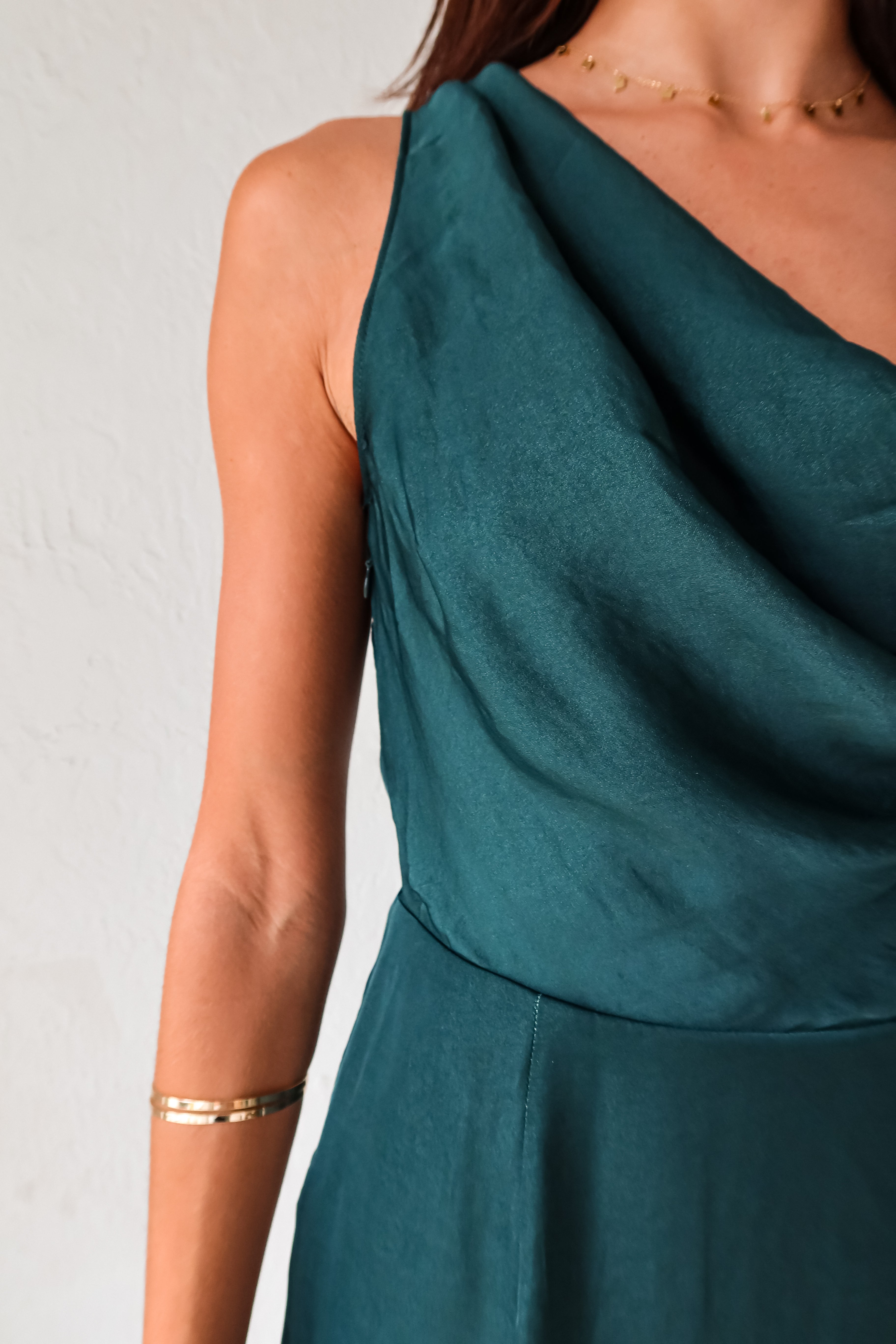 Get ready to turn heads in our ELLE SATIN MINI DRESS! Made from luxurious forest green satin, this mini dress features a side zipper closure for a perfect fit and a draped back for a touch of elegance. Perfect for any occasion