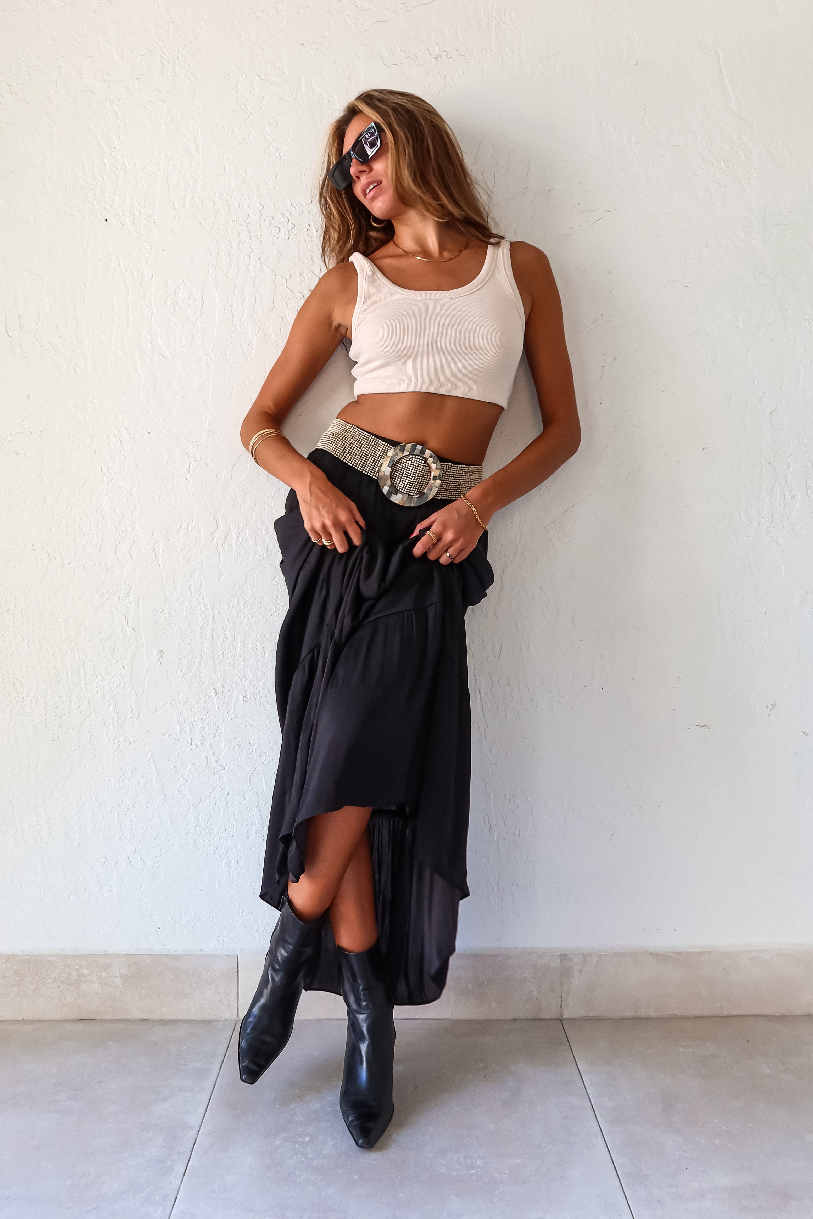  elegance and edge to your wardrobe with the Venus Satin Maxi Skirt in black! The non-stretch satin fabric flows beautifully while the elastic waistband provides a comfortable and flattering fit. Fully lined for a luxe feel 