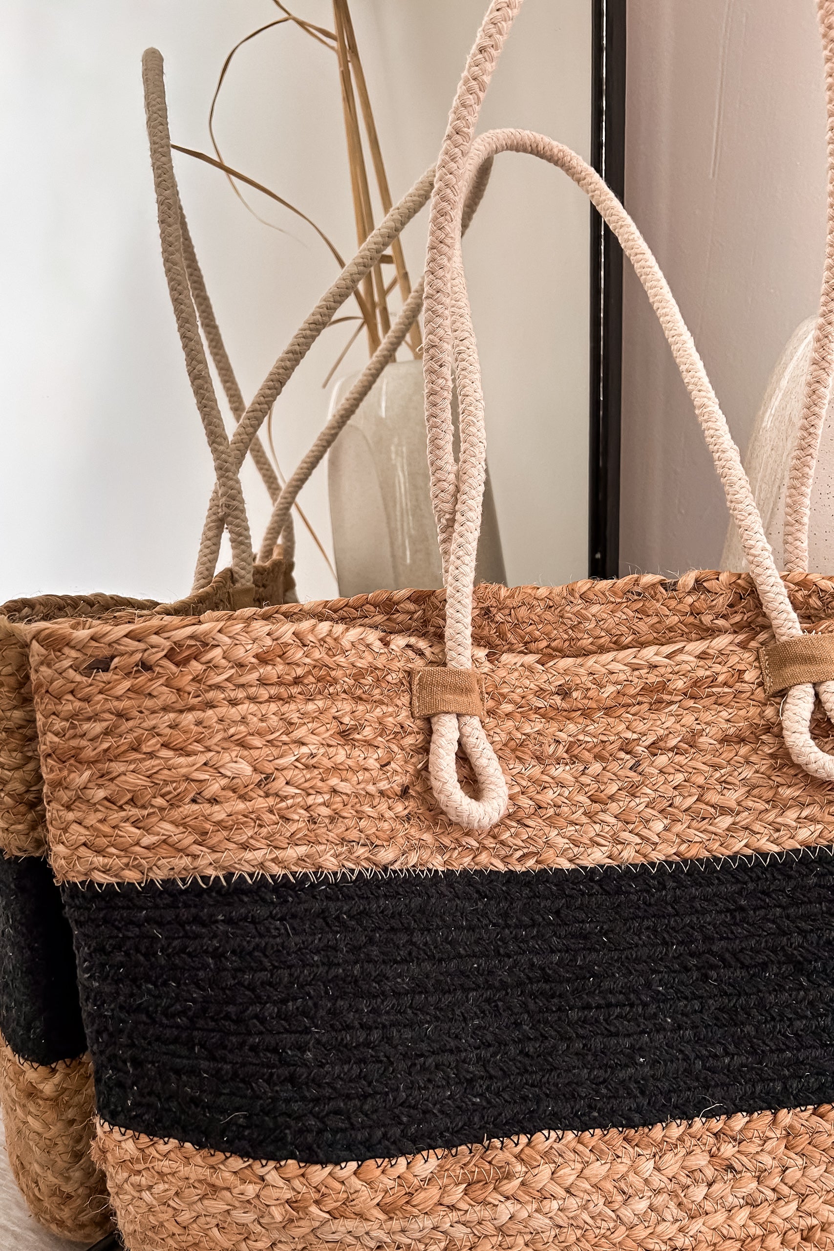 Get carried away with the LOKAL WOVEN TOTE. This spacious tote features a stylish open top design and striking rope handle detailing. Its 14in length, 12in height, and 7.5in width make it the perfect size for all your essentials. Get ready to turn heads with this brown/black beauty.