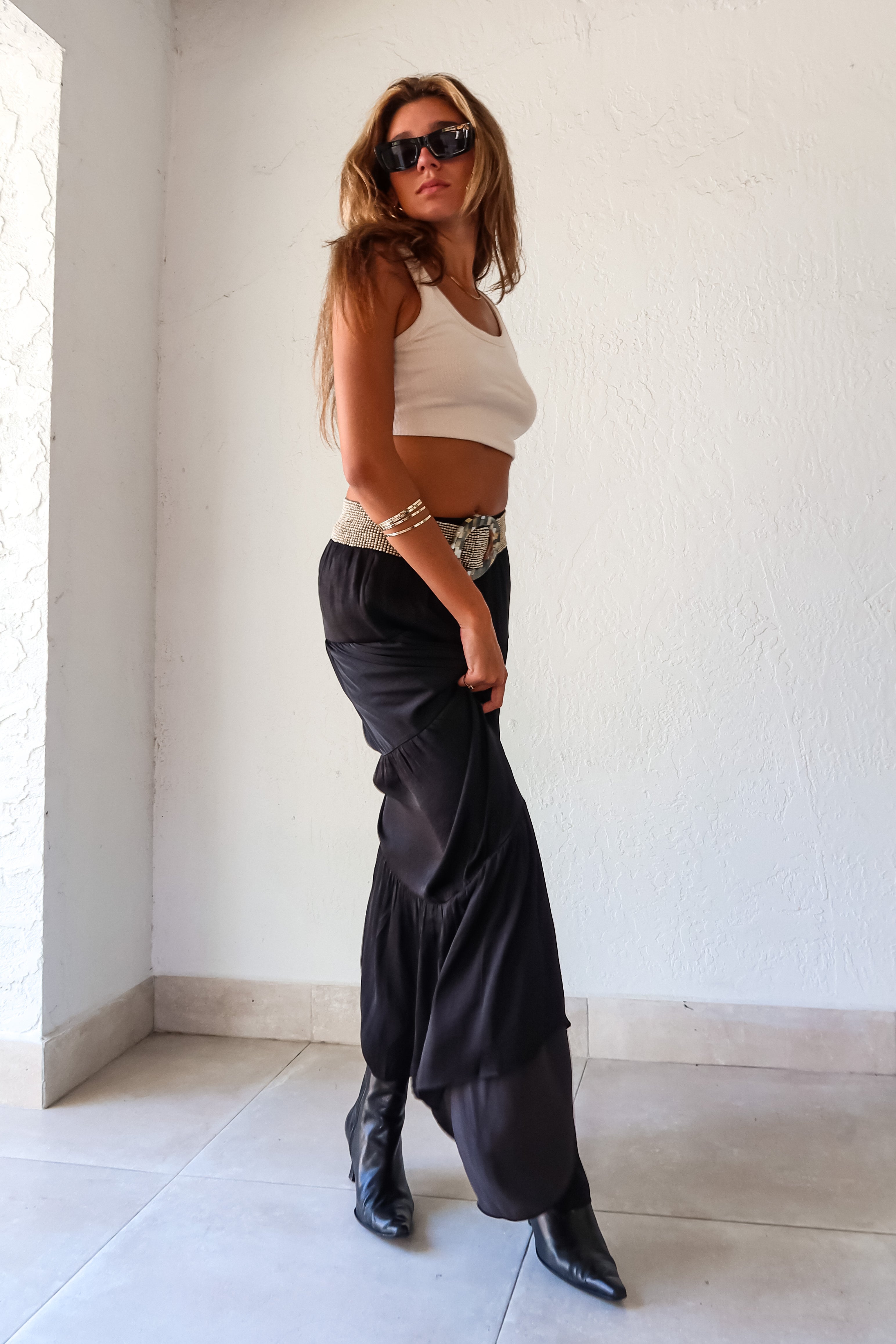  elegance and edge to your wardrobe with the Venus Satin Maxi Skirt in black! The non-stretch satin fabric flows beautifully while the elastic waistband provides a comfortable and flattering fit. Fully lined for a luxe feel 