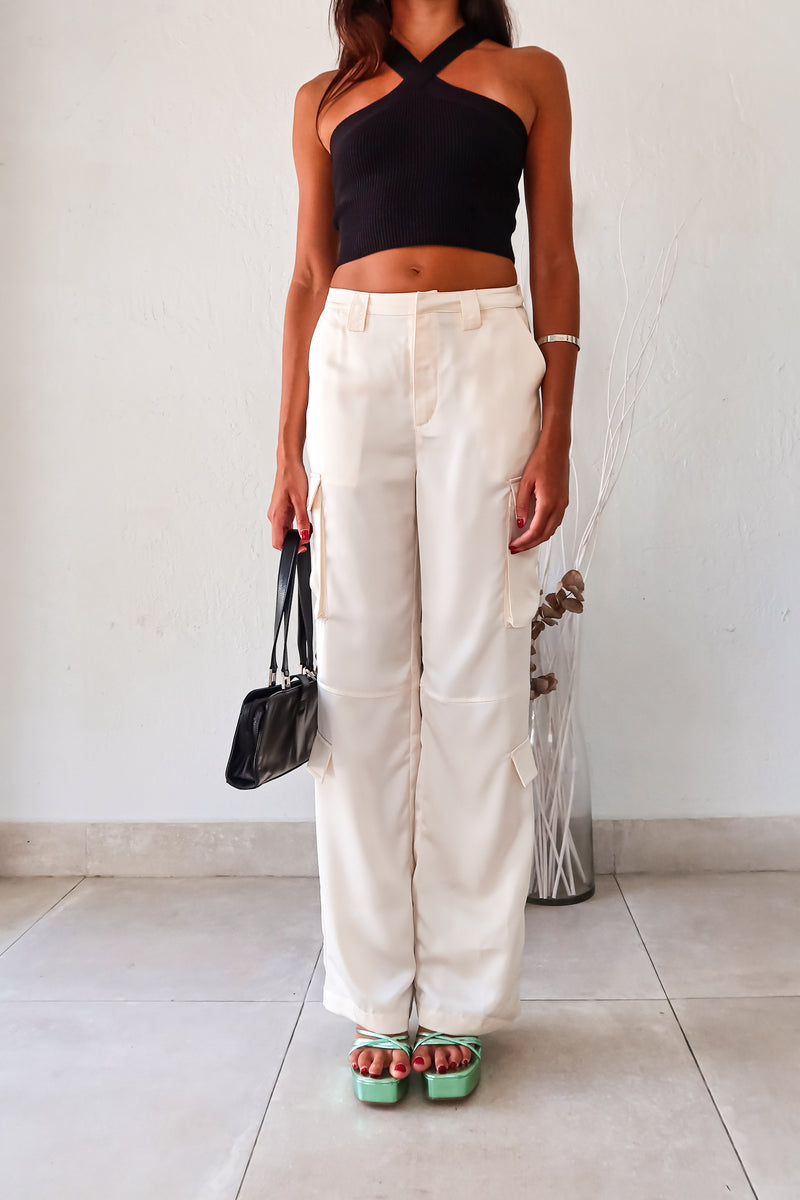 Make a statement on your first date in our FIRST DATE SATIN PANT. The cream color and wide leg style exude elegance, while the side cargo pockets add functionality. With a zipper clip closure and elastic stretch waistband, you'll be comfortable all night long.