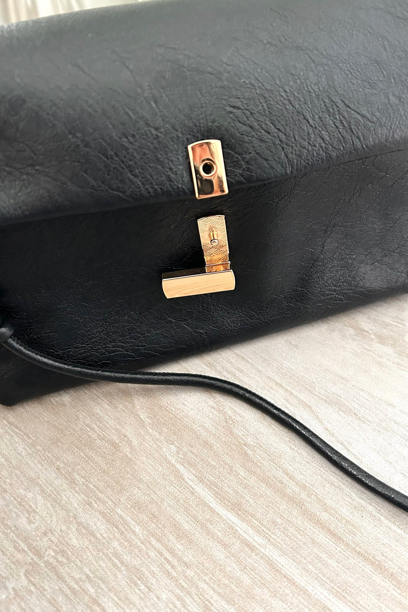 Introducing the LEXI PURSE - the perfect accessory for any outfit! Made with black or gold vegan leather, this purse is both stylish and sustainable. Carry it with ease thanks to the removable hand strap and secure your belongings with the gold buckle closure. 