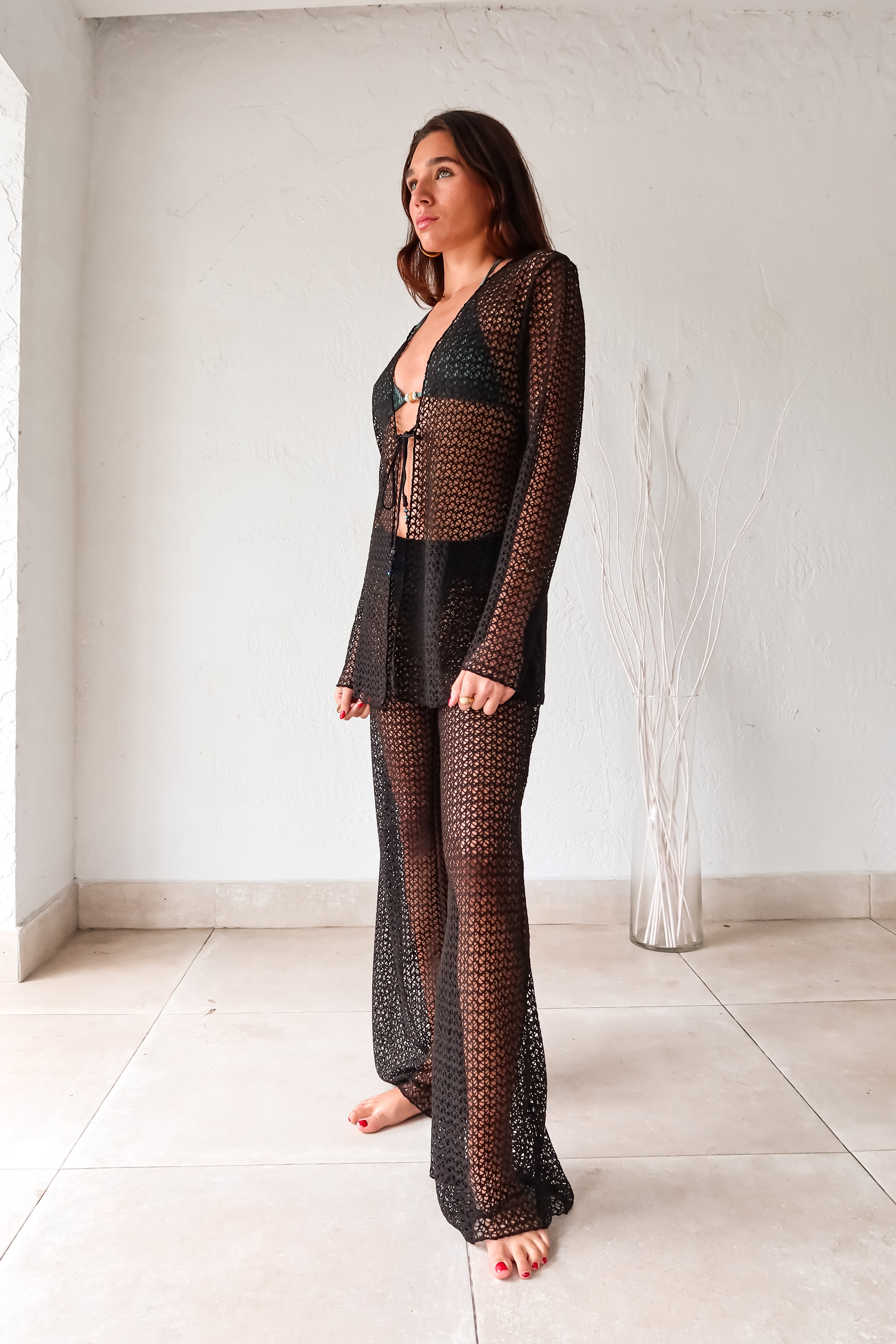 Get ready to slay in style with our NEWPORT PANT - BLACK! These versatile cover up pants are a must-have for any wardrobe. The wide leg design creates a flowy silhouette, while the elastic waist ensures a comfortable fit. Made from stretchy fabric, these pants offer both style and flexibility.