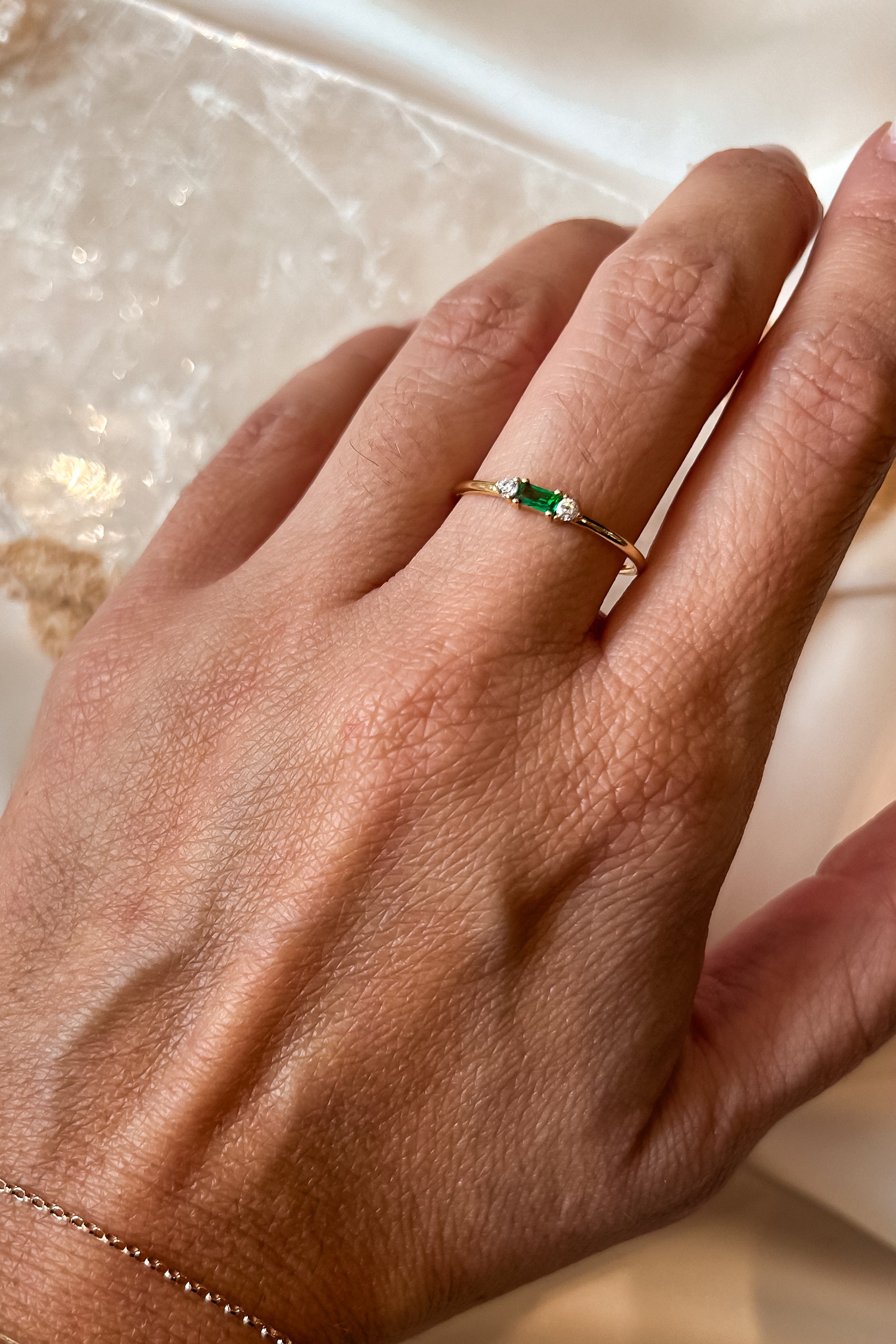 Add a touch of sparkle to your ensemble with our Vermeil Emerald Ring. This playful piece features a gold-plated 925 sterling silver band and a stunning emerald gemstone. Its tarnish resistant design ensures long-lasting wear. Sized for a perfect fit.