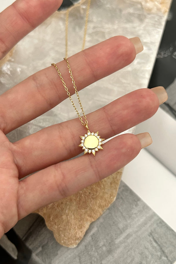 Add a golden ray of sunshine to your jewelry collection with our PAVE SUN RAY NECKLACE. Made with gold plated sterling silver, this necklace features a playful sun charm with gem details. Enjoy the benefits of tarnish resistance and hypoallergenic materials without sacrificing style!