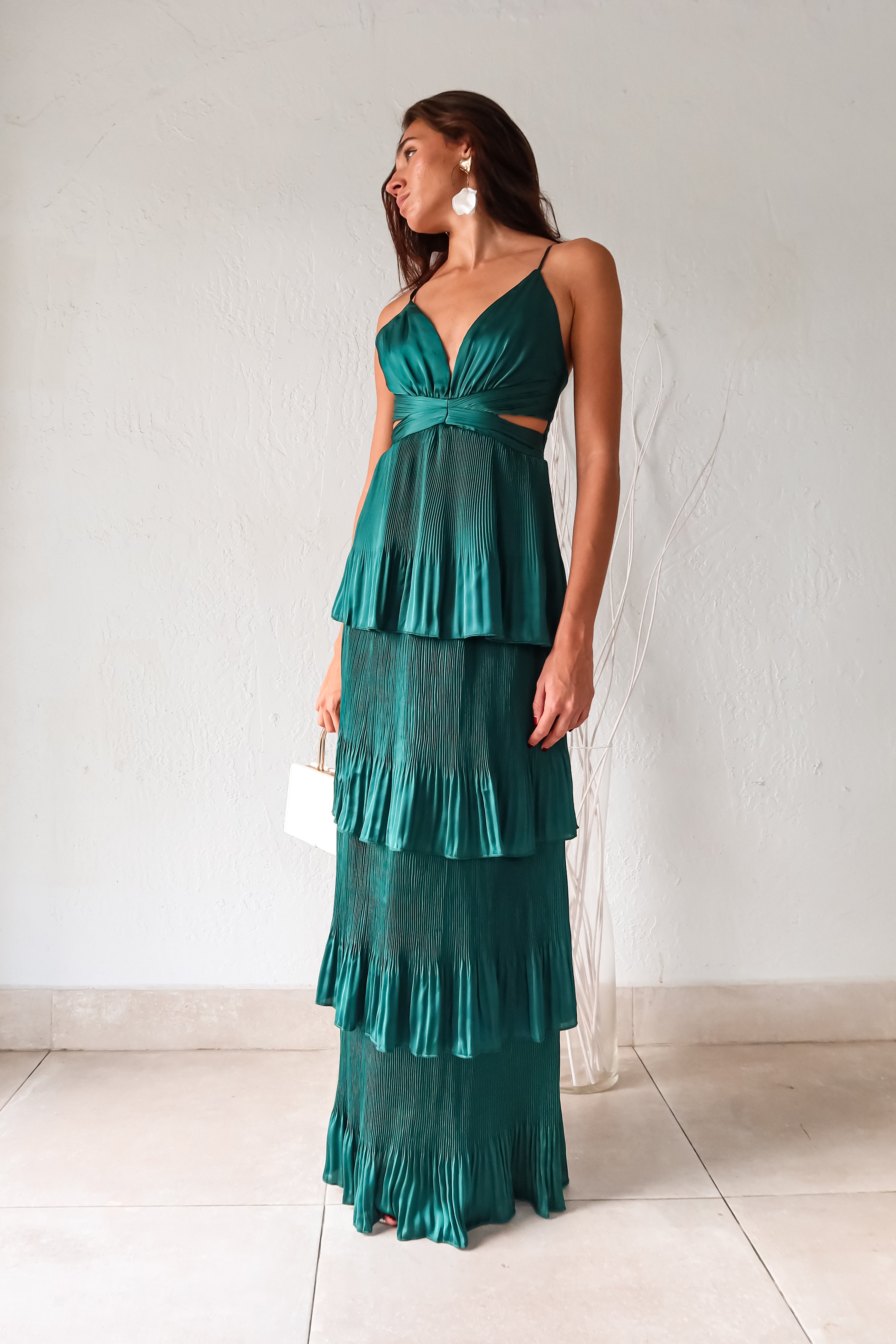 Turn heads in the PARISIAN GARDEN SATIN MAXI DRESS. With an emerald green satin fabric, adjustable shoulder straps, and a back zipper closure, this dress is both comfortable and stunning. The chiffon overlap detail adds a touch of elegance to this playful and chic piece.