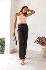 Get ready to make some bold moves with these black satin pants. The button and zipper closure, along with the elastic waist band, ensure a comfortable fit while the front pockets add functionality. Perfect for a night out on the town, these pants will have you looking stylish and feeling confident.