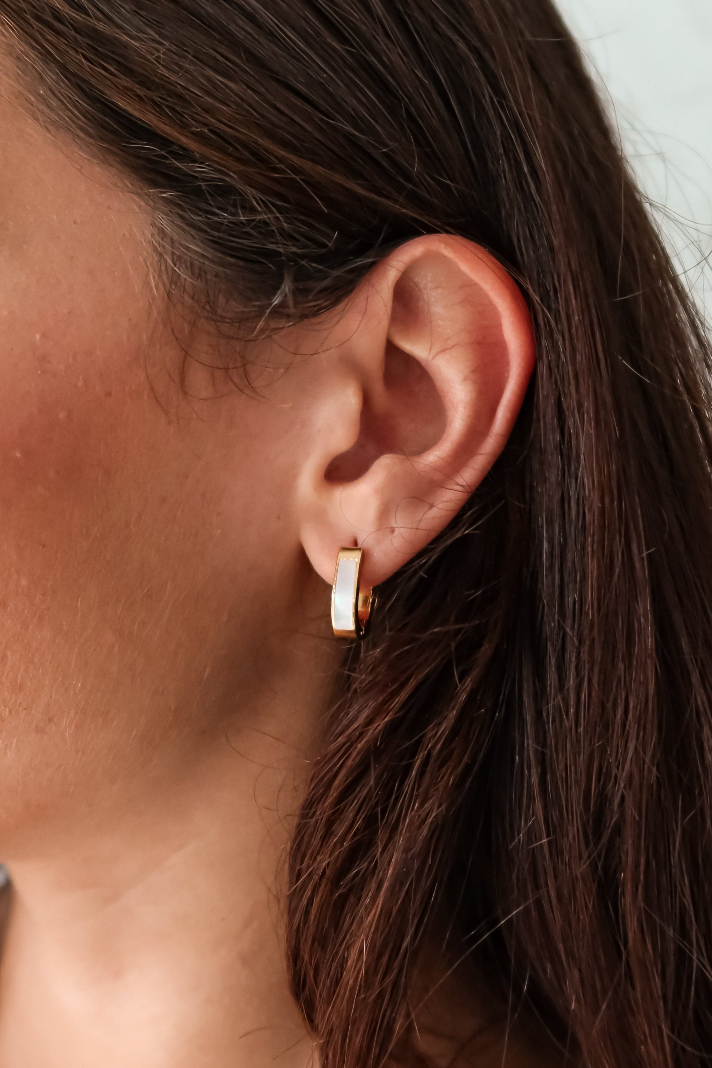 Treat yo'self to the ultimate earring upgrade: ST MOP HUGGIES. Made of gold plated sterling silver, these huggies feature a pearl front detail, are tarnish resistant, and hypoallergenic.