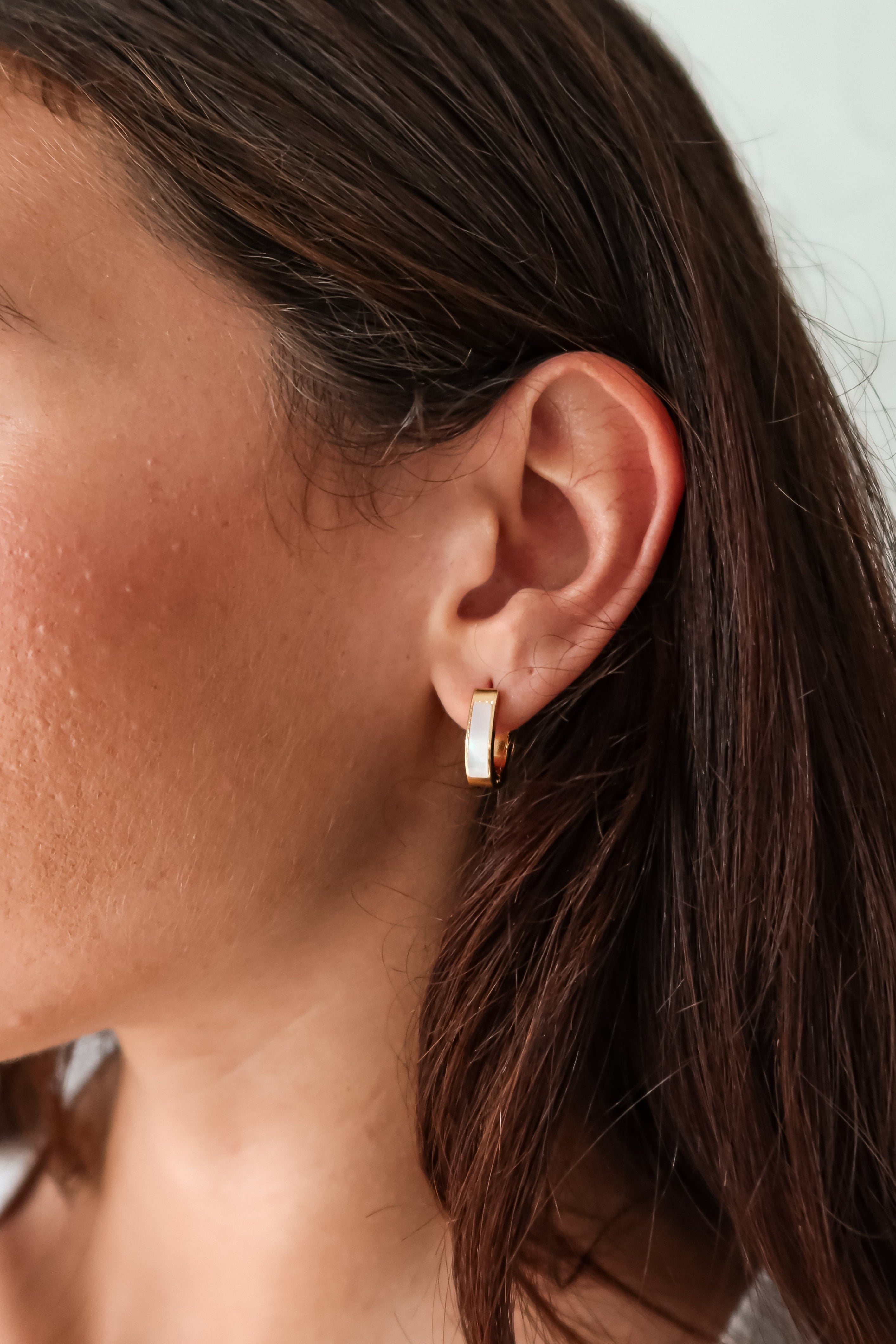 Treat yo'self to the ultimate earring upgrade: ST MOP HUGGIES. Made of gold plated sterling silver, these huggies feature a pearl front detail, are tarnish resistant, and hypoallergenic.