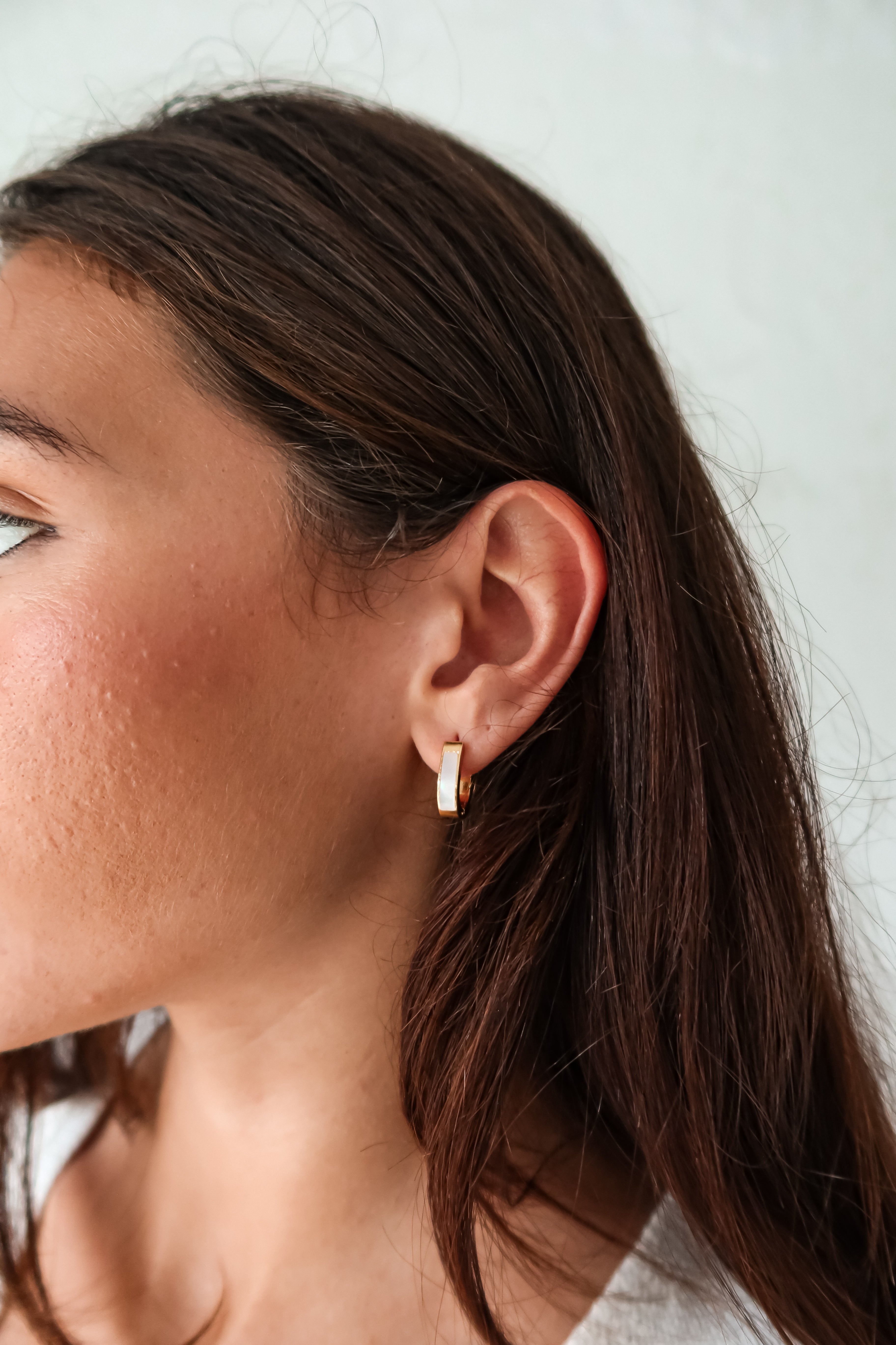 Treat yo'self to the ultimate earring upgrade: ST MOP HUGGIES. Made of gold plated sterling silver, these huggies feature a pearl front detail, are tarnish resistant, and hypoallergenic.