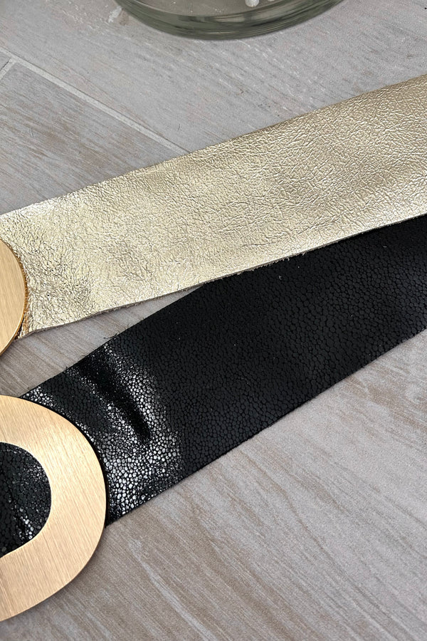 Upgrade your fashion game with the Leather Roma Belt, available in two colors: black and gold. Made from vegan leather, this belt features a trendy gold hoop buckle for a stylish touch.