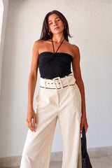 Effortlessly chic and comfortable, the ECLIPSE KNIT TOP in black is a must-have for your wardrobe. Made with ribbed stretchy fabric, it features a front knot design and a unique tie around the neck. Perfect for pairing with the Napoli Belted Linen Pant and the Silvana Woven Tote. Don't forget to size down for the perfect fit!