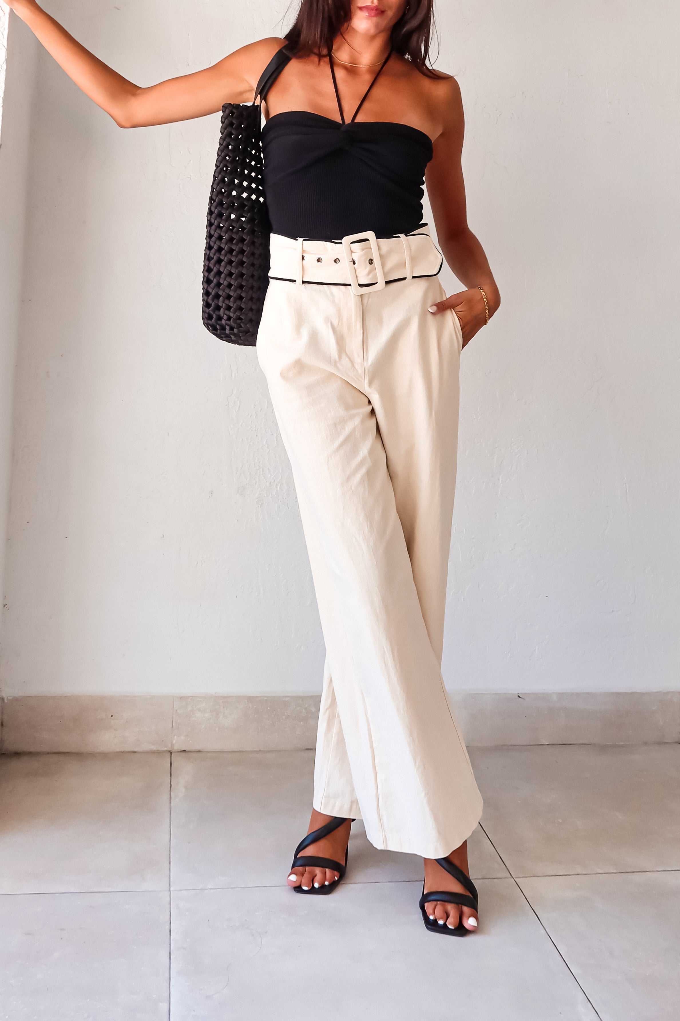 Unleash your inner fashionista with our Napoli Belted Linen Pant! In a chic cream color with contrasting black trim at the waistline, these pants will elevate any outfit. Complete with front pockets, zipper button closure, and an optional belt, these non-stretch, non-lined pants run true to size. Hand wash cold and pair them with the Eclipse Knit Top and Silvana Woven Tote for a stylish, effortless look.