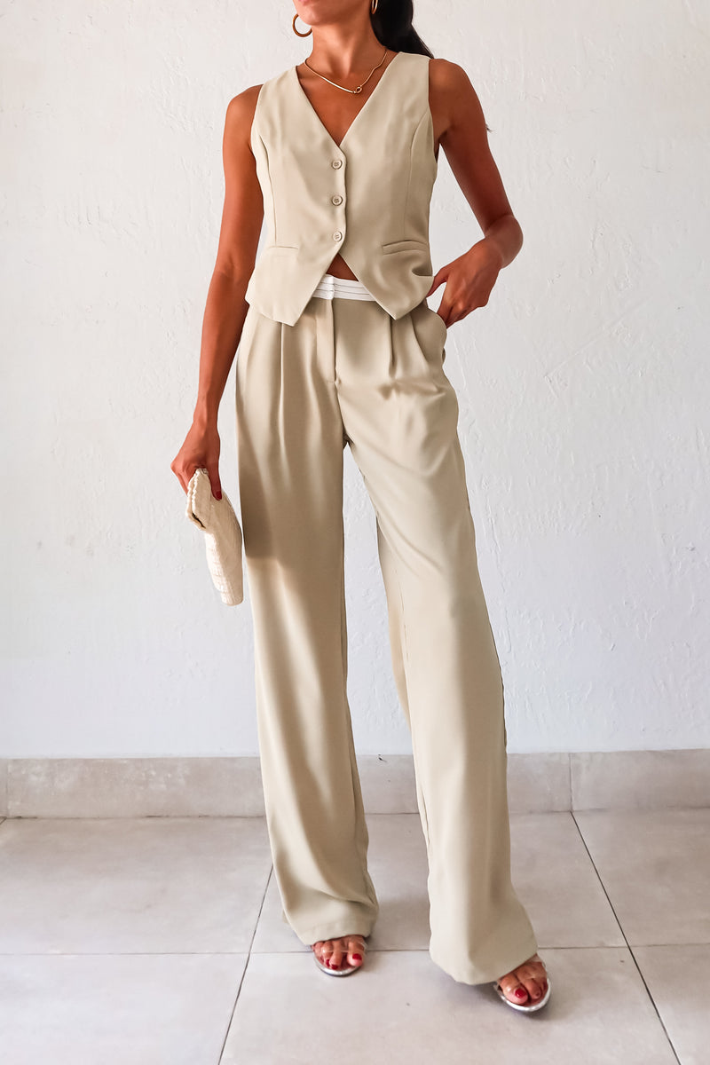 This sage green vest pant set adds a touch of charm to your wardrobe. Features a top with adjustable buckle silver detail and front button closure, while the pants offer a pleated design with white waist detail and front pockets. 