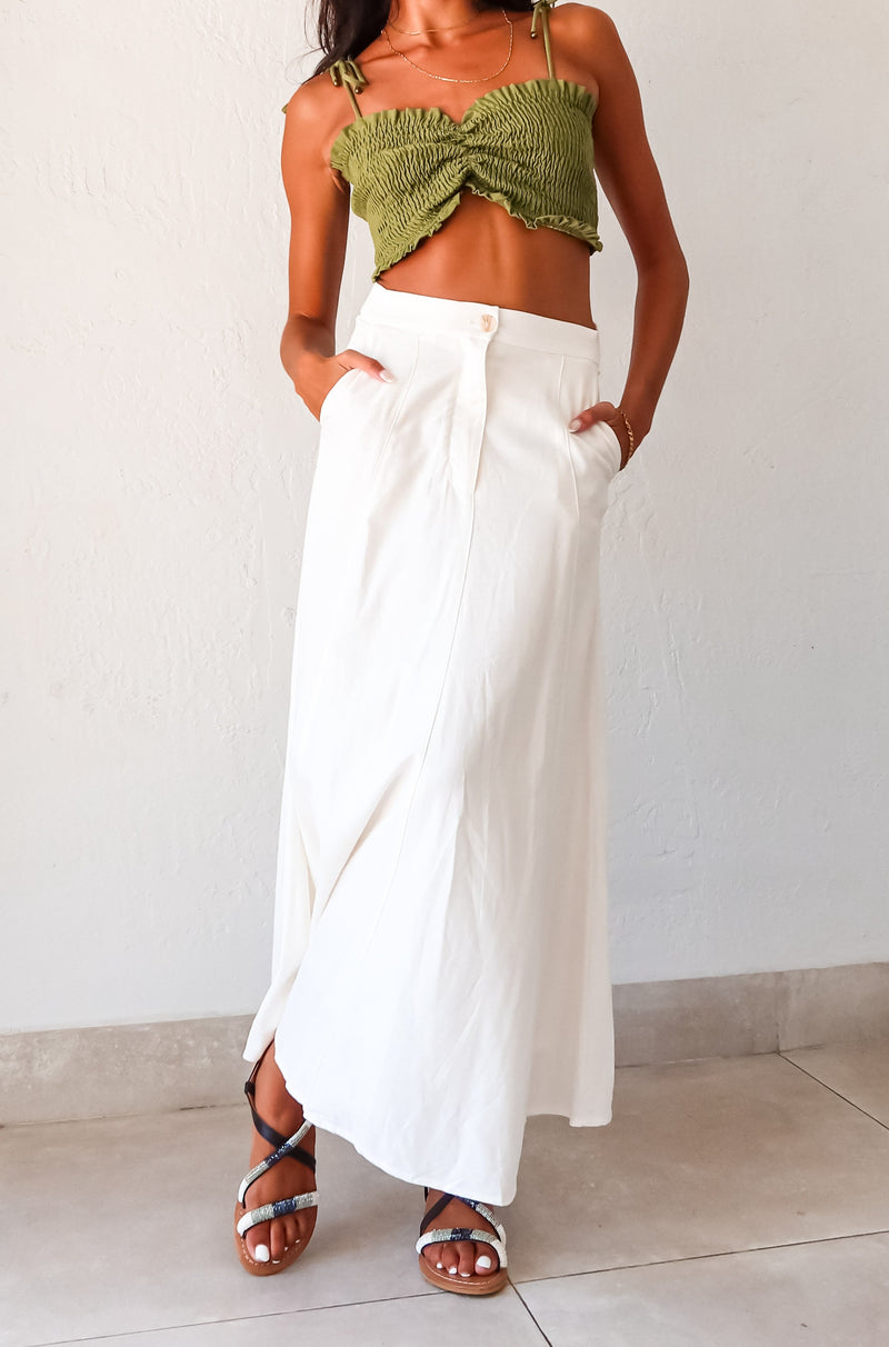 Unleash your inner boho-chic with the MISOMMAR LINEN MAXI SKIRT. Made of breathable white linen, this pleated maxi skirt features convenient front pockets and a secure zipper button closure. The non-stretch fabric adds structure, while the lining ensures comfort. Pair with the Arcadia Smart Crop Top for a trendy and effortlessly stylish look.