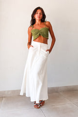 Unleash your inner boho-chic with the MISOMMAR LINEN MAXI SKIRT. Made of breathable white linen, this pleated maxi skirt features convenient front pockets and a secure zipper button closure. The non-stretch fabric adds structure, while the lining ensures comfort. Pair with the Arcadia Smart Crop Top for a trendy and effortlessly stylish look.