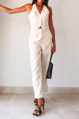 On the Boardwalk Linen Jumpsuit! This beige linen jumpsuit features a vest top with front button closure pocket detail and an open torso for a breezy look. With a bottom zipper clip closure and lining, this non-stretch jumpsuit is perfect for a day out. Runs true to size, Sofia wears size small. Made with a blend of Viscose, Linen, and Polyester