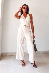 On the Boardwalk Linen Jumpsuit! This beige linen jumpsuit features a vest top with front button closure pocket detail and an open torso for a breezy look. With a bottom zipper clip closure and lining, this non-stretch jumpsuit is perfect for a day out. Runs true to size, Sofia wears size small. Made with a blend of Viscose, Linen, and Polyester