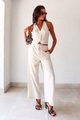 On the Boardwalk Linen Jumpsuit! This beige linen jumpsuit features a vest top with front button closure pocket detail and an open torso for a breezy look. With a bottom zipper clip closure and lining, this non-stretch jumpsuit is perfect for a day out. Runs true to size, Sofia wears size small. Made with a blend of Viscose, Linen, and Polyester