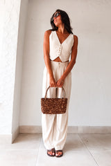 Get ready to be stylish and comfortable in our On The Way Linen Pant Set in oatmeal beige! The vest top features a front button closure and the pants have a zipper and button closure, as well as front pockets and belt loops for added convenience. The stretchy waist back ensures a comfortable fit and the top is fully lined for added coverage. 