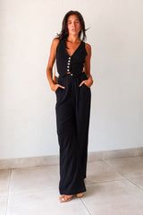 Slip into comfort and style with the ON THE WAY LINEN PANT SET in black. This versatile pant set features a vest top with a front button closure and pants with a zipper button closure. With front pockets, a stretchy waist back, and a lined top, it's the perfect mix of fashion and functionality. No need to compromise comfort for style, as this non-stretch set runs true to size.