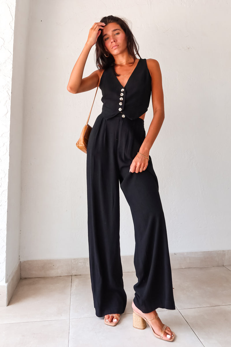 Slip into comfort and style with the ON THE WAY LINEN PANT SET in black. This versatile pant set features a vest top with a front button closure and pants with a zipper button closure. With front pockets, a stretchy waist back, and a lined top, it's the perfect mix of fashion and functionality. No need to compromise comfort for style, as this non-stretch set runs true to size.