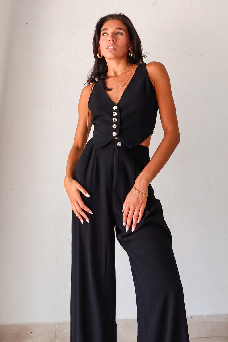 Slip into comfort and style with the ON THE WAY LINEN PANT SET in black. This versatile pant set features a vest top with a front button closure and pants with a zipper button closure. With front pockets, a stretchy waist back, and a lined top, it's the perfect mix of fashion and functionality. No need to compromise comfort for style, as this non-stretch set runs true to size.