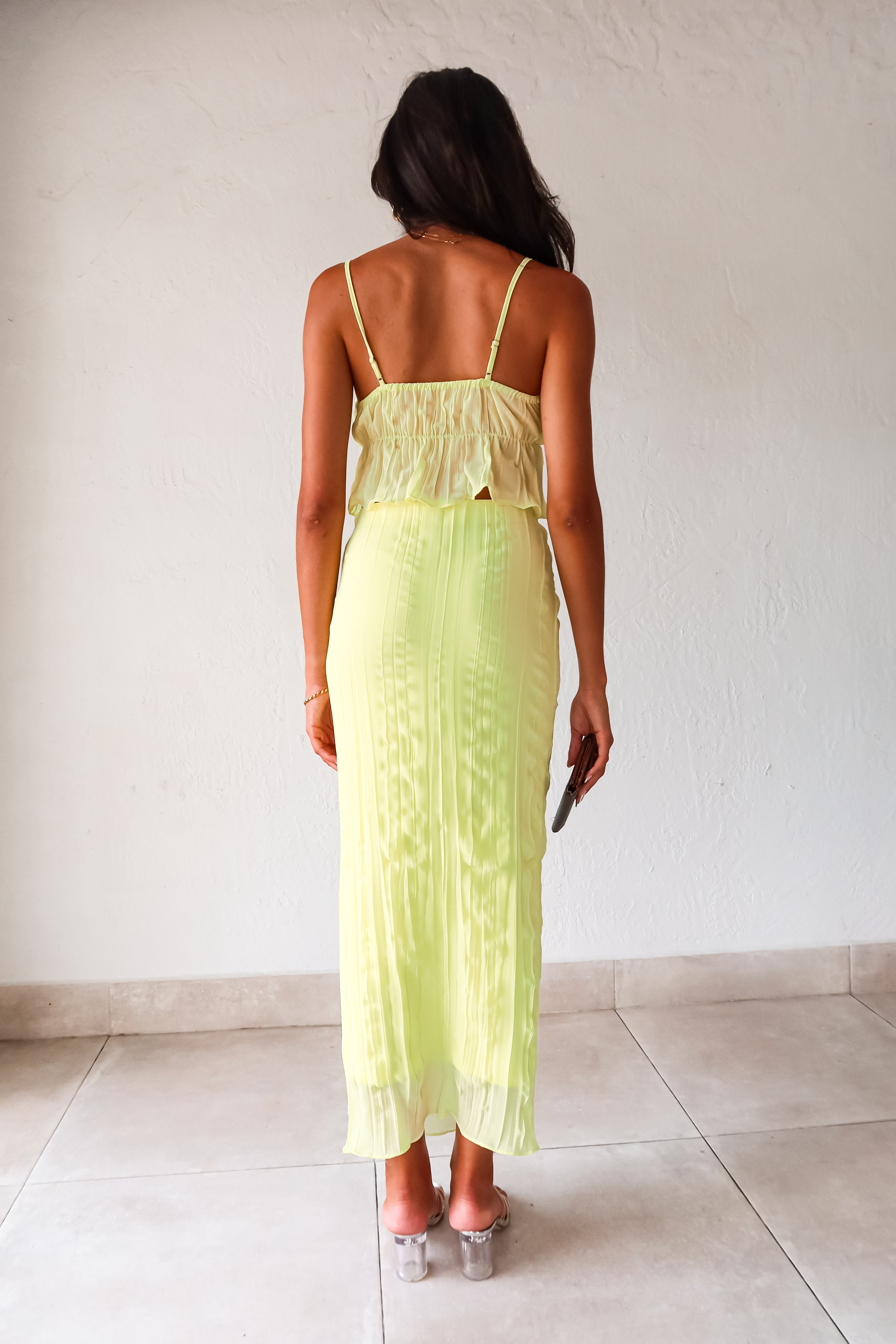 The LUELLA PLISSE CHIFFON SKIRT SET in fluorescent yellow/green is sure to make a statement. The crop top features adjustable shoulder straps and is lined at the bust for added comfort. The midi skirt has an elastic waistband and is also lined. Perfect for a fun and playful look. Hand wash cold.