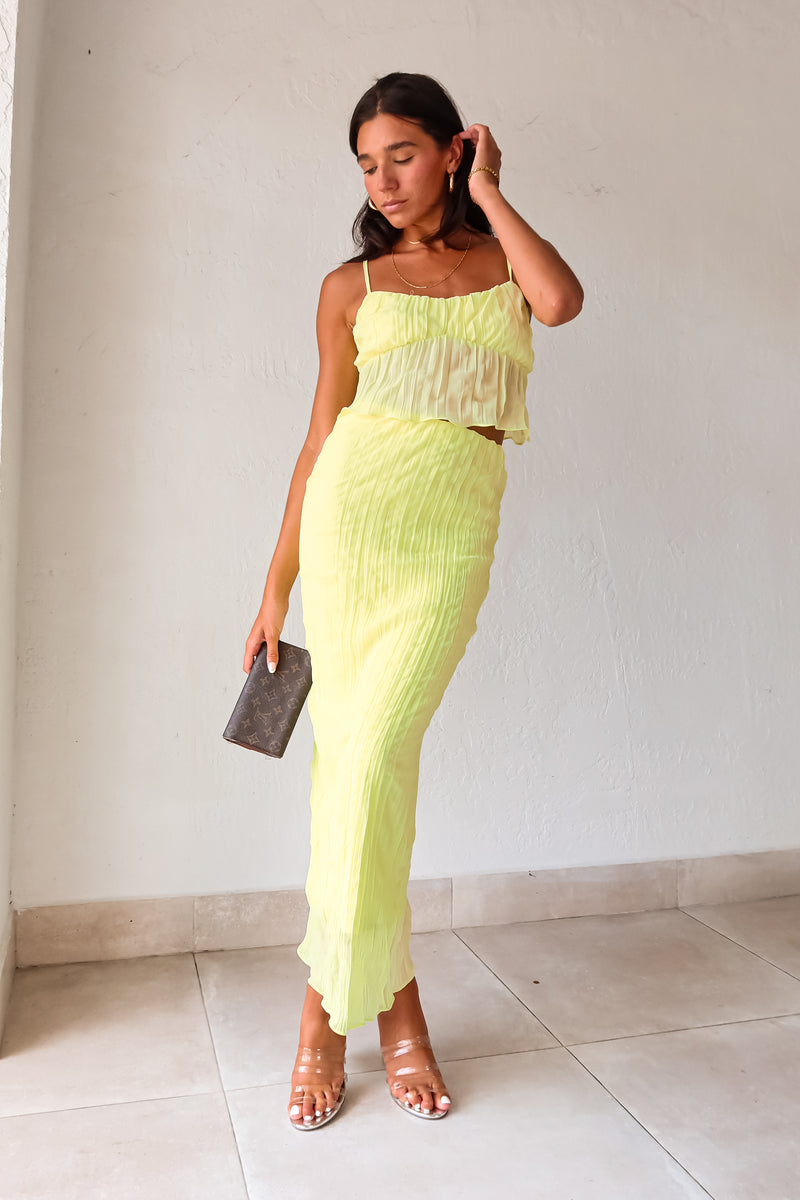 The LUELLA PLISSE CHIFFON SKIRT SET in fluorescent yellow/green is sure to make a statement. The crop top features adjustable shoulder straps and is lined at the bust for added comfort. The midi skirt has an elastic waistband and is also lined. Perfect for a fun and playful look. Hand wash cold.