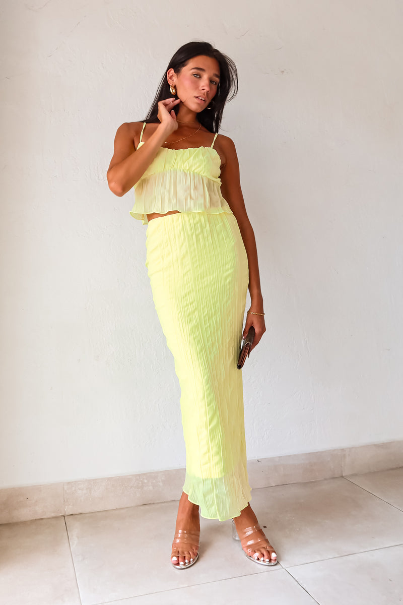 The LUELLA PLISSE CHIFFON SKIRT SET in fluorescent yellow/green is sure to make a statement. The crop top features adjustable shoulder straps and is lined at the bust for added comfort. The midi skirt has an elastic waistband and is also lined. Perfect for a fun and playful look. Hand wash cold.