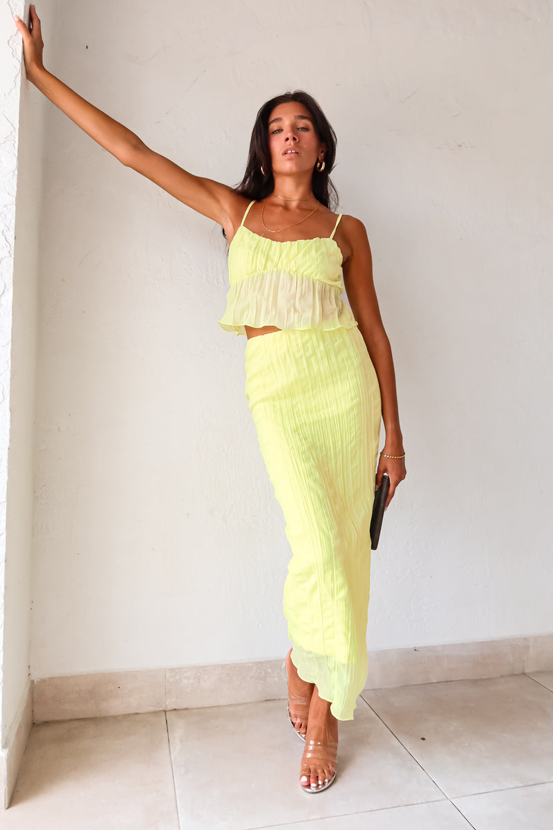 The LUELLA PLISSE CHIFFON SKIRT SET in fluorescent yellow/green is sure to make a statement. The crop top features adjustable shoulder straps and is lined at the bust for added comfort. The midi skirt has an elastic waistband and is also lined. Perfect for a fun and playful look. Hand wash cold.