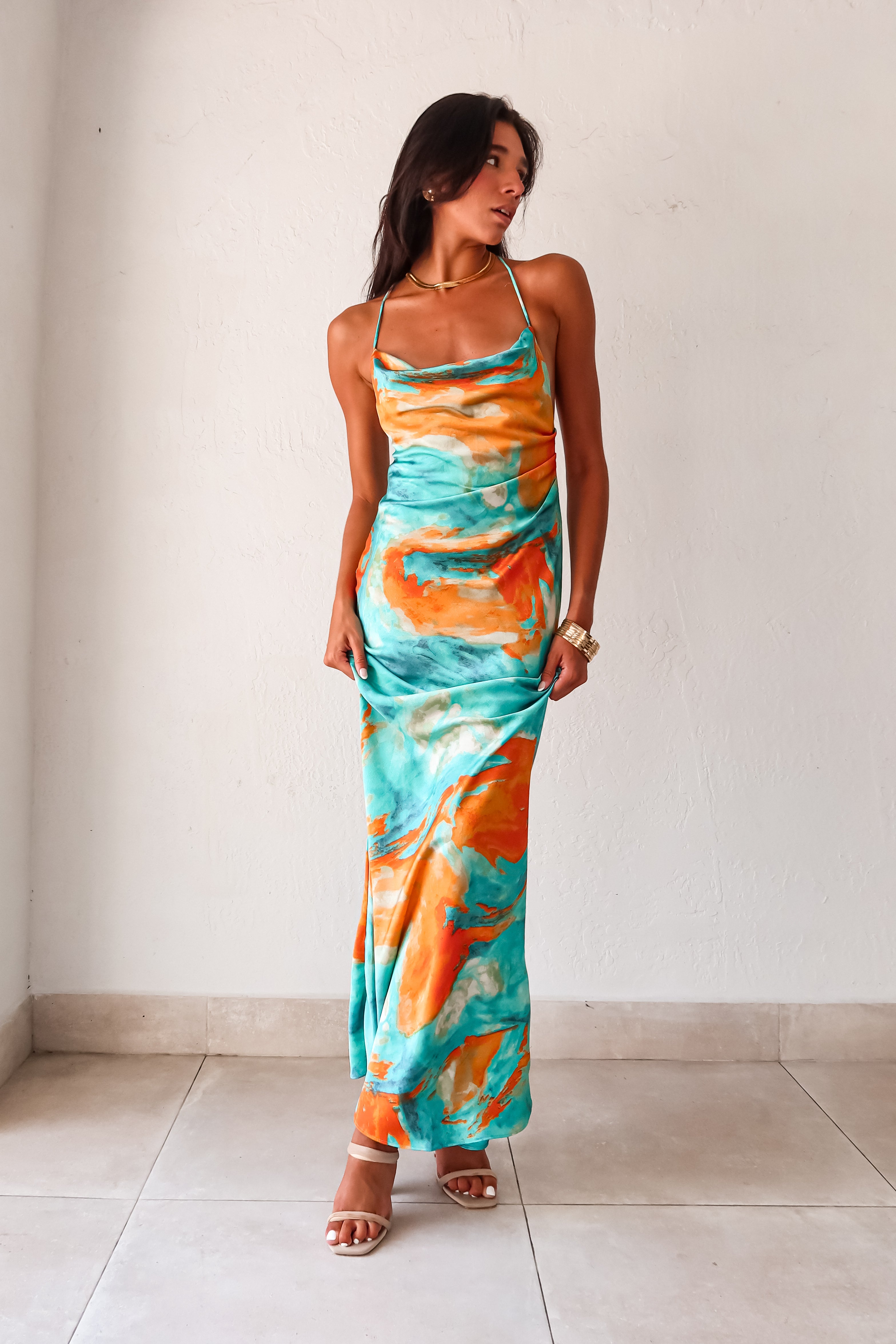 Sunset Views satin maxi dress - now in 2 new colors! This luxe crinkle dress features a cowl neck bust, low draped back, and gold chain detail. Its side pleating and non-stretch fabric make it perfect for any special occasion.