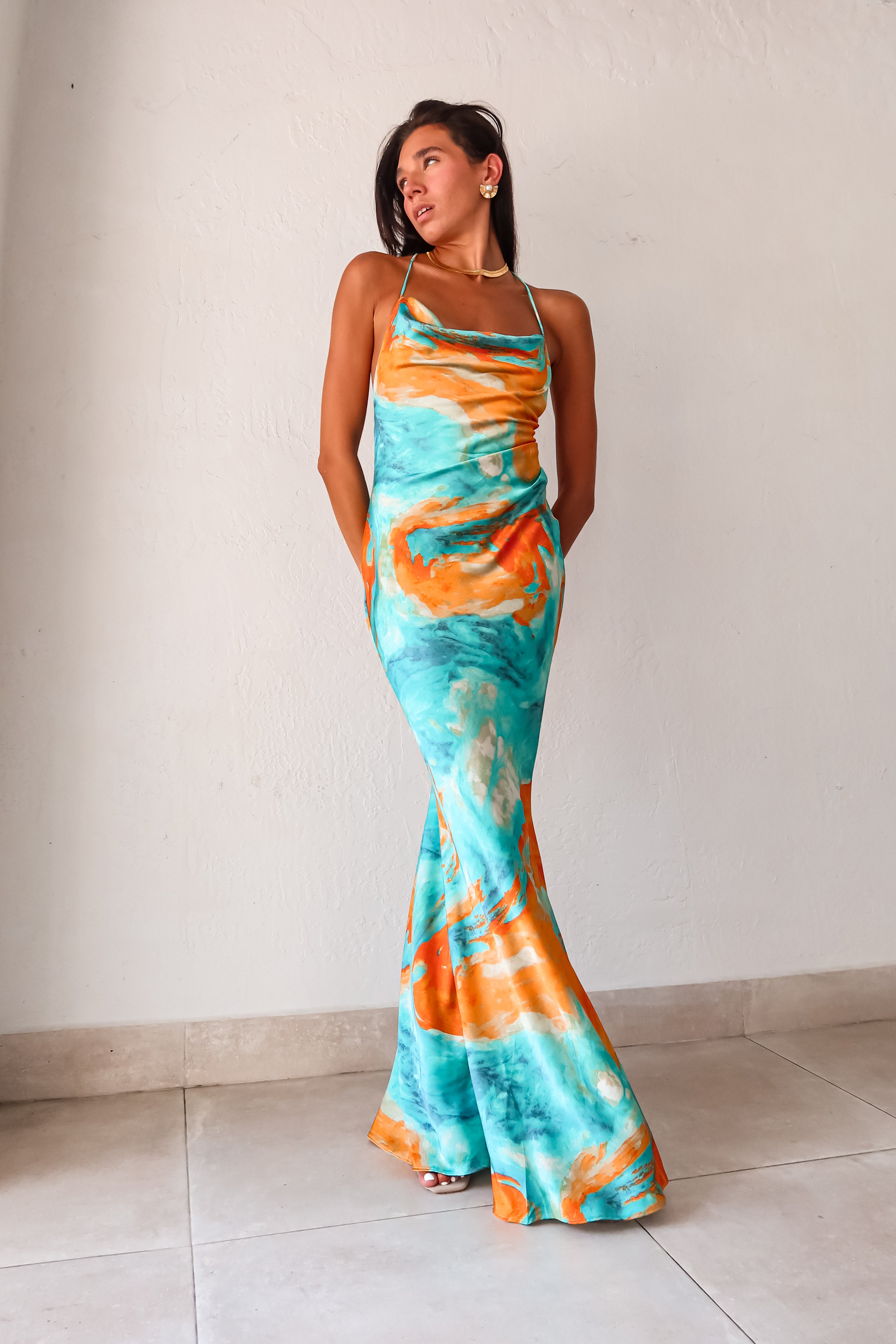 Sunset Views satin maxi dress - now in 2 new colors! This luxe crinkle dress features a cowl neck bust, low draped back, and gold chain detail. Its side pleating and non-stretch fabric make it perfect for any special occasion.