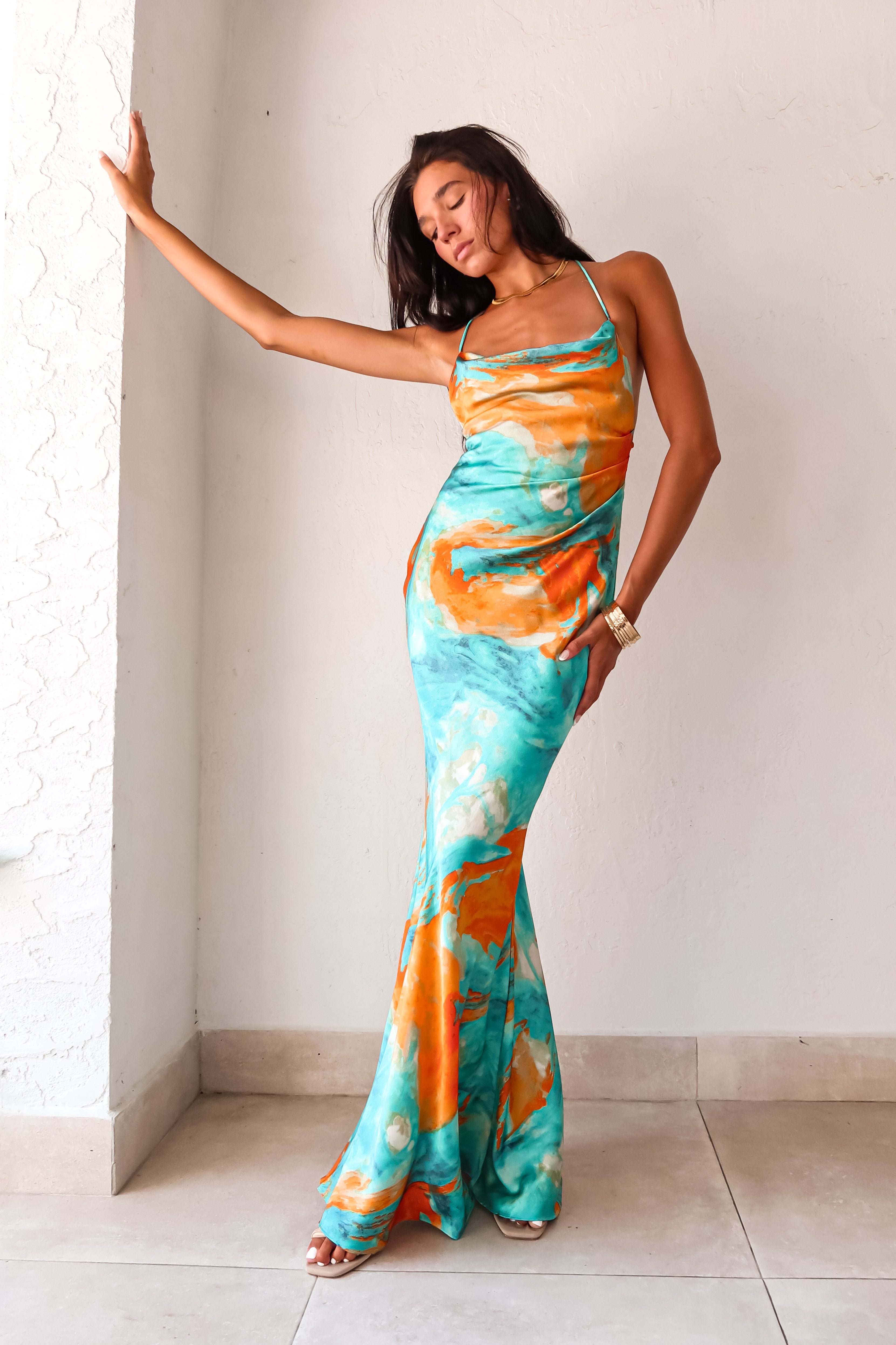 Sunset Views satin maxi dress - now in 2 new colors! This luxe crinkle dress features a cowl neck bust, low draped back, and gold chain detail. Its side pleating and non-stretch fabric make it perfect for any special occasion.