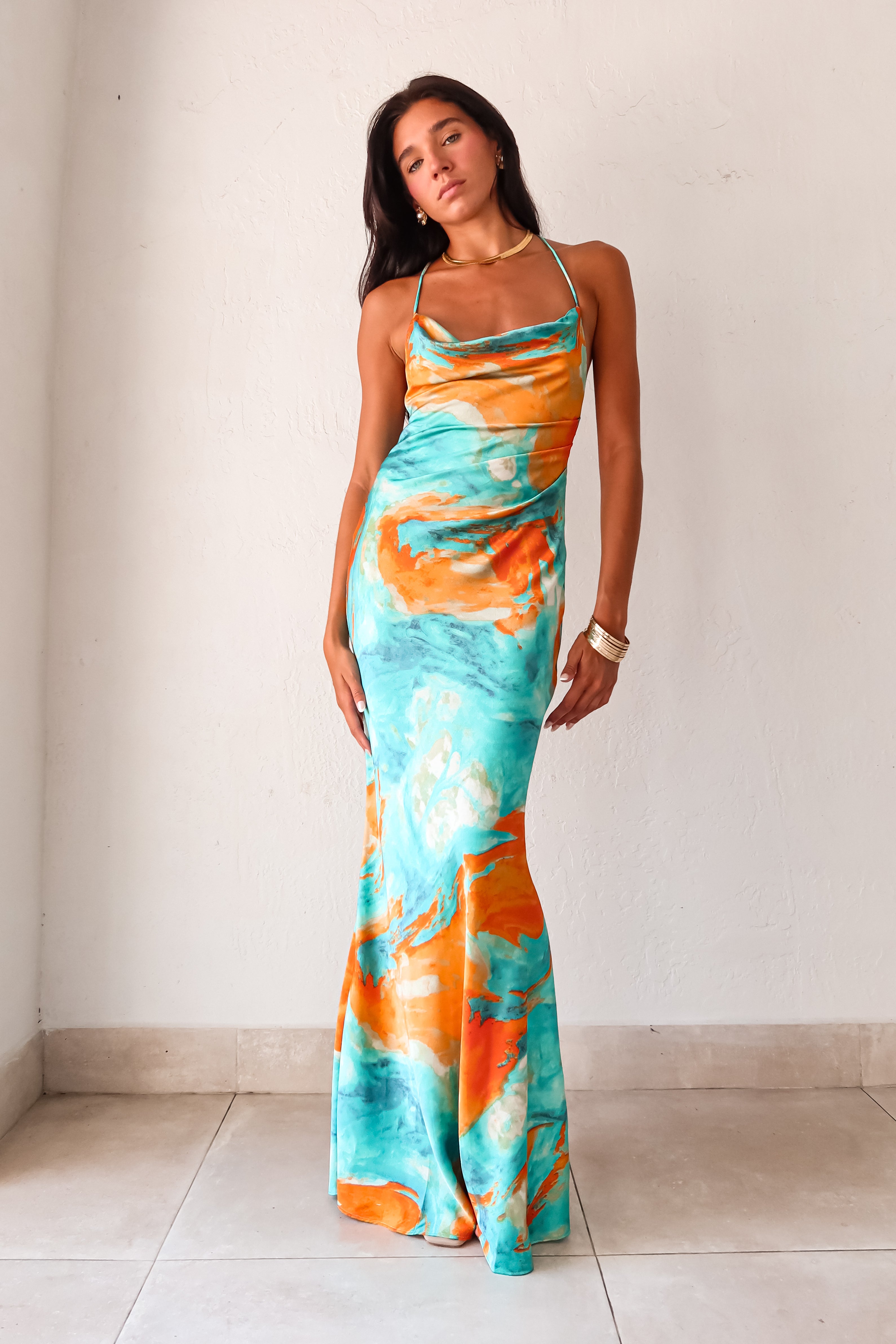 Sunset Views satin maxi dress - now in 2 new colors! This luxe crinkle dress features a cowl neck bust, low draped back, and gold chain detail. Its side pleating and non-stretch fabric make it perfect for any special occasion.