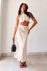  TOP TIER SKIRT SET! This beige light denim maxi skirt set features a halter cropped top that ties around the neck and a high waist maxi skirt with a raw edge design and hem. With a flattering fit and non-stretch, non-lined fabric, this set is perfect for any occasion. Pair it with our Becca Woven Mini bag for a complete look. 