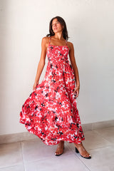 Be the life of the party in our WONDERLAND VISION MAXI DRESS! This floral dress features a playful red, pink, white, and black design, with an adjustable tie string back and smocked bust for a comfortable and flattering fit. With non-lined, non-stretch material and one size fitting XS-L, you'll be sure to turn heads in this quirky, fun dress.