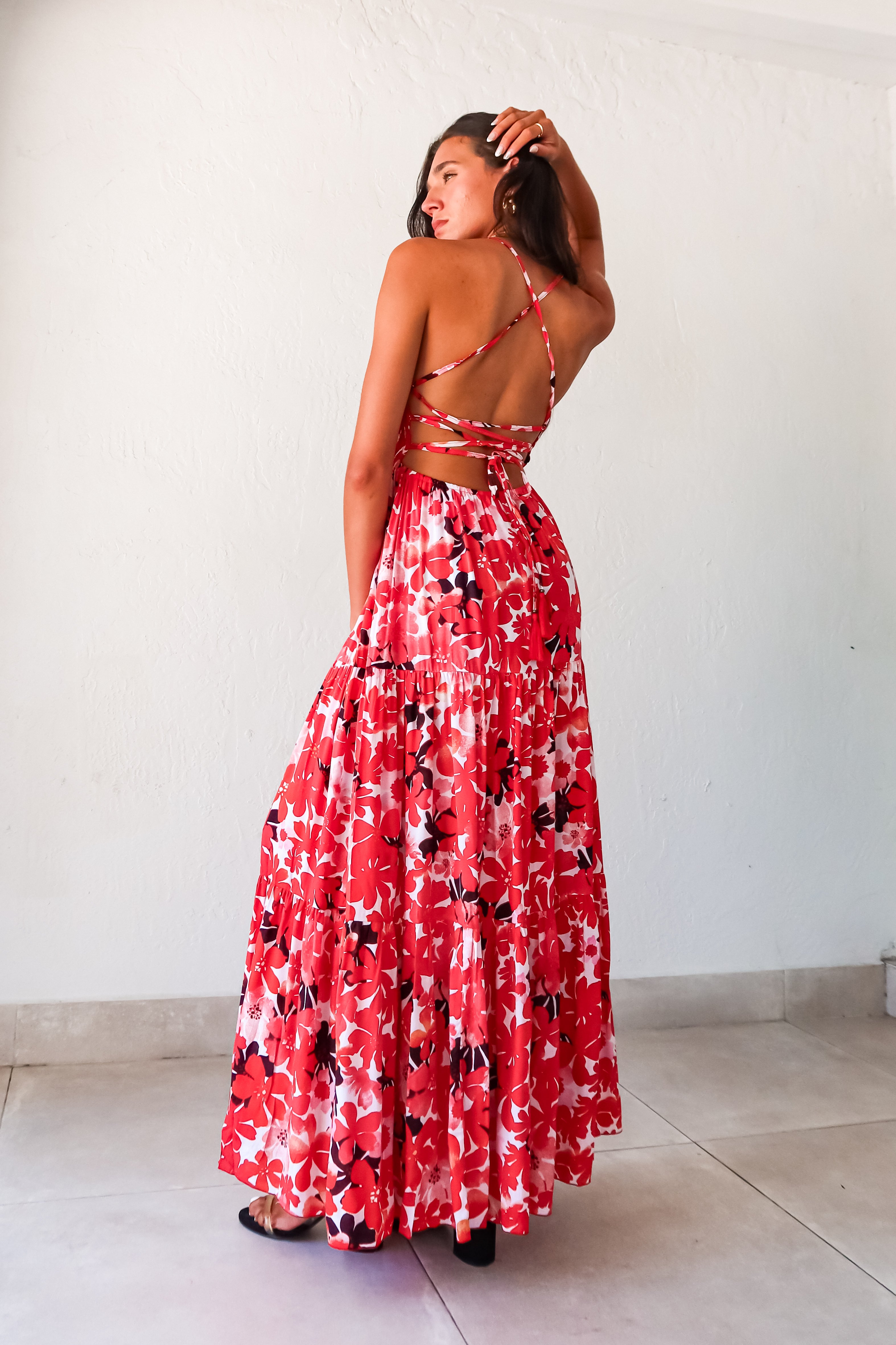 Be the life of the party in our WONDERLAND VISION MAXI DRESS! This floral dress features a playful red, pink, white, and black design, with an adjustable tie string back and smocked bust for a comfortable and flattering fit. With non-lined, non-stretch material and one size fitting XS-L, you'll be sure to turn heads in this quirky, fun dress.