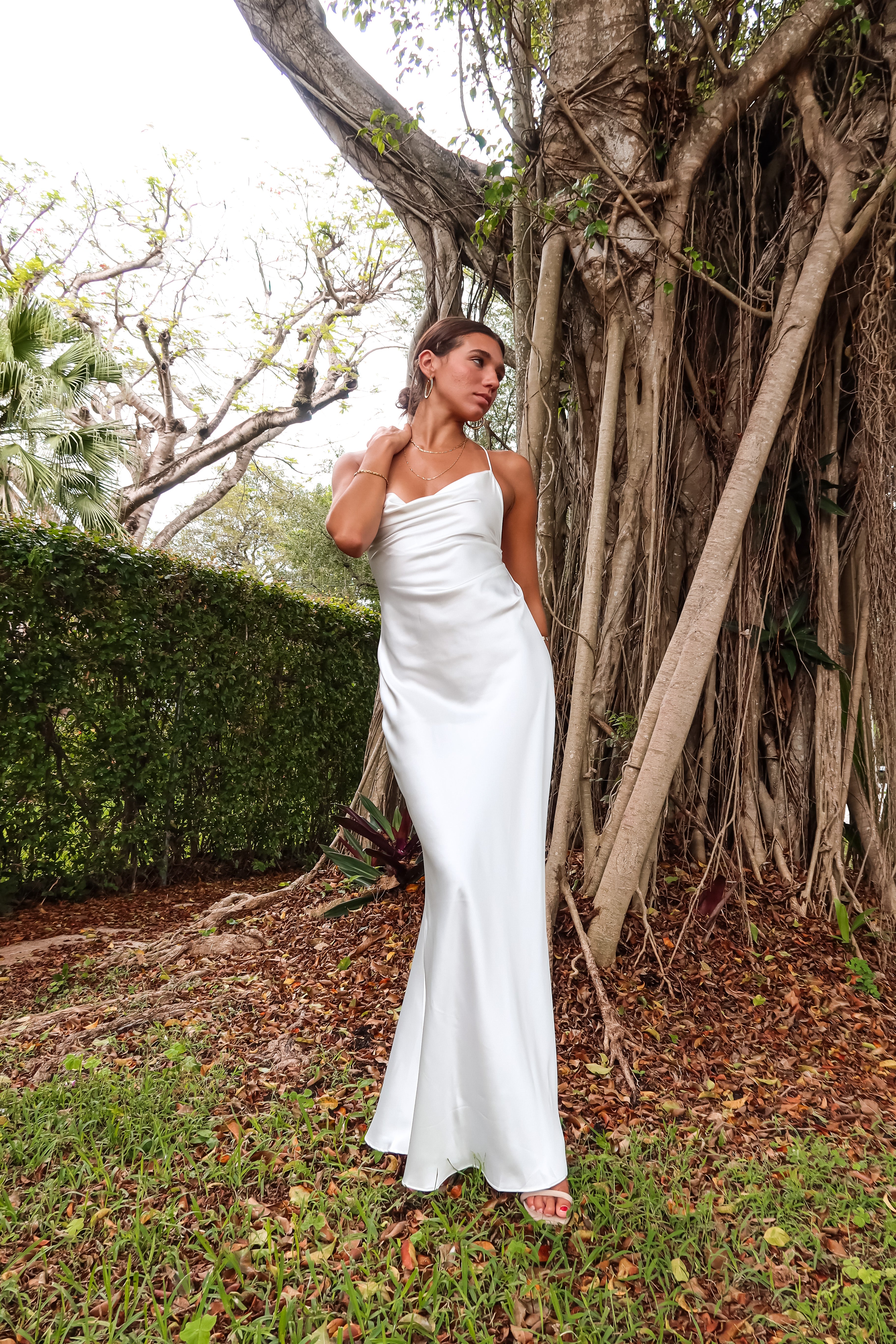 Get ready to party in our white satin maxi dress! Luxurious and thick satin fabric provides ultimate comfort and style. Adjustable string tie with gold chain detail adds a touch of glamour. Cowl neck bust and low back create a stunning silhouette. Let's get this party started!