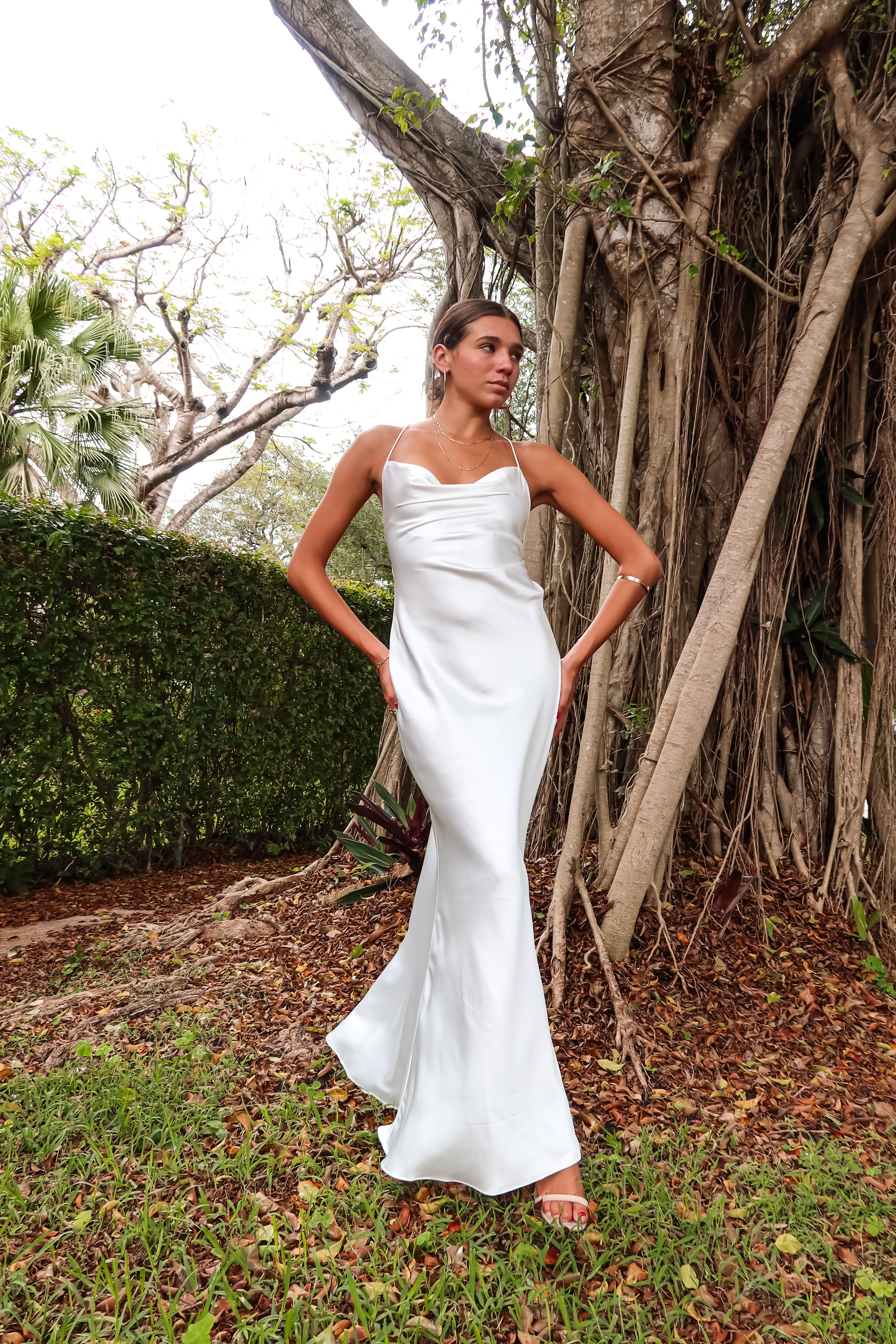 Get ready to party in our white satin maxi dress! Luxurious and thick satin fabric provides ultimate comfort and style. Adjustable string tie with gold chain detail adds a touch of glamour. Cowl neck bust and low back create a stunning silhouette. Let's get this party started!