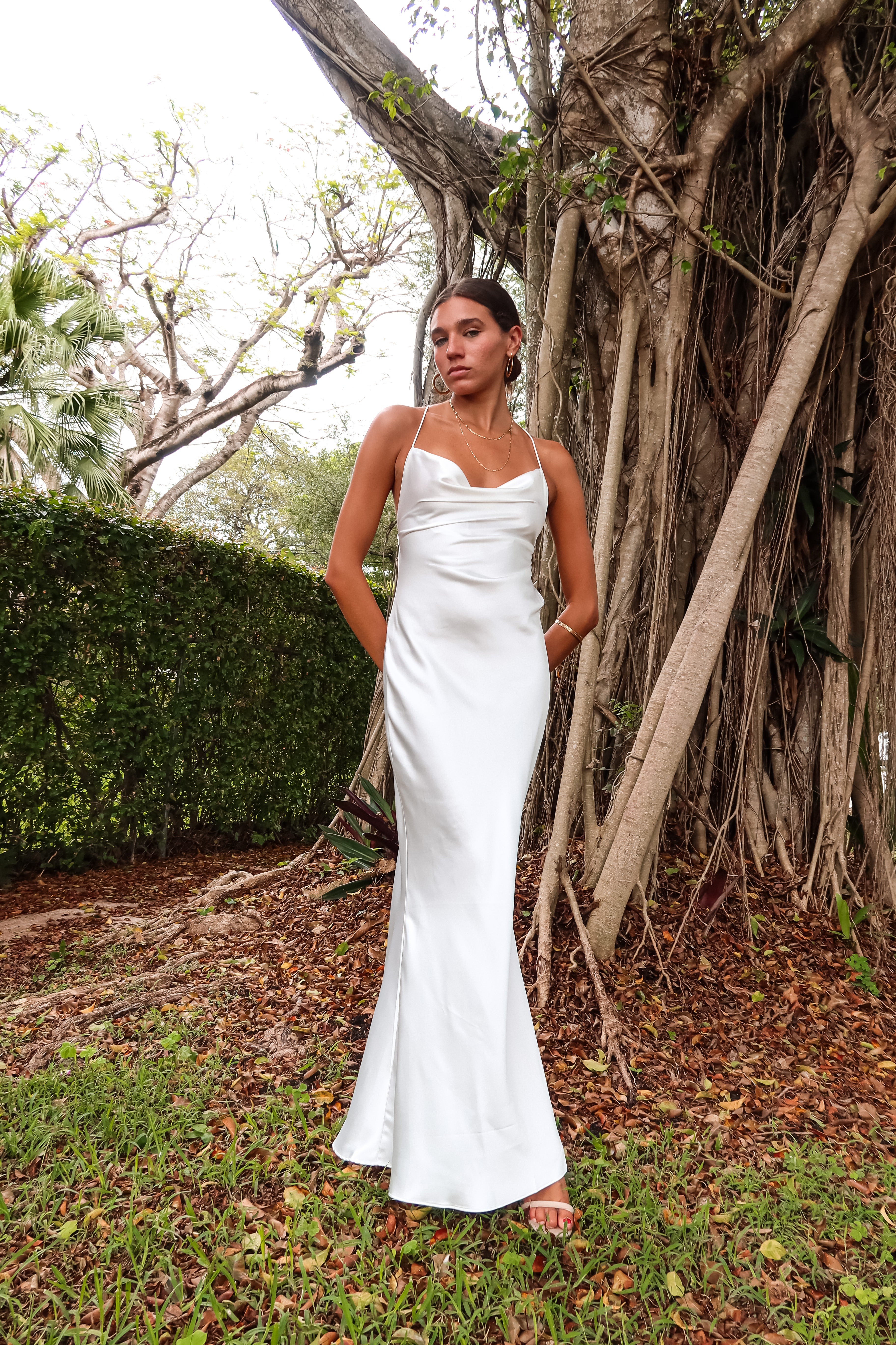 Get ready to party in our white satin maxi dress! Luxurious and thick satin fabric provides ultimate comfort and style. Adjustable string tie with gold chain detail adds a touch of glamour. Cowl neck bust and low back create a stunning silhouette. Let's get this party started!