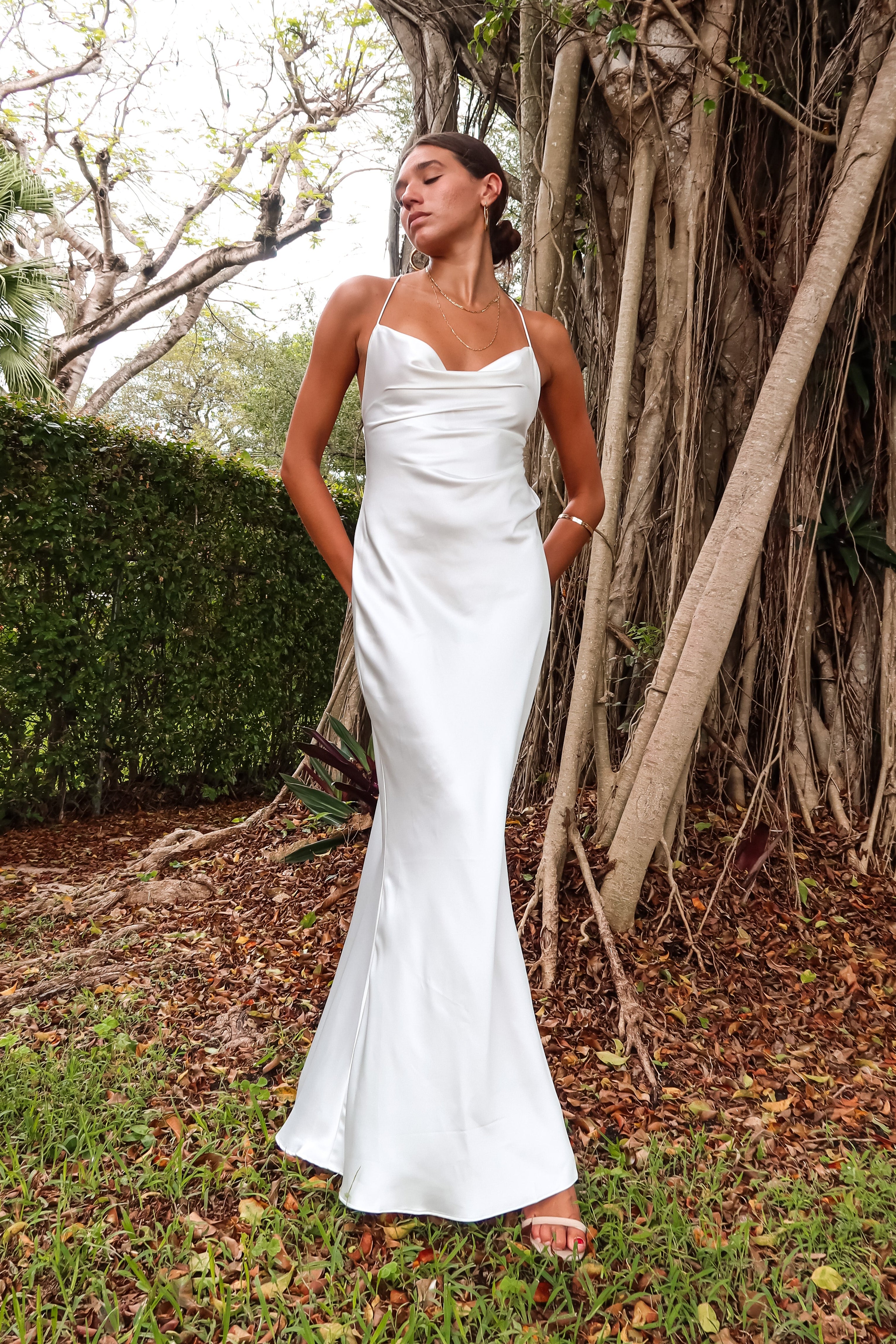 Get ready to party in our white satin maxi dress! Luxurious and thick satin fabric provides ultimate comfort and style. Adjustable string tie with gold chain detail adds a touch of glamour. Cowl neck bust and low back create a stunning silhouette. Let's get this party started!