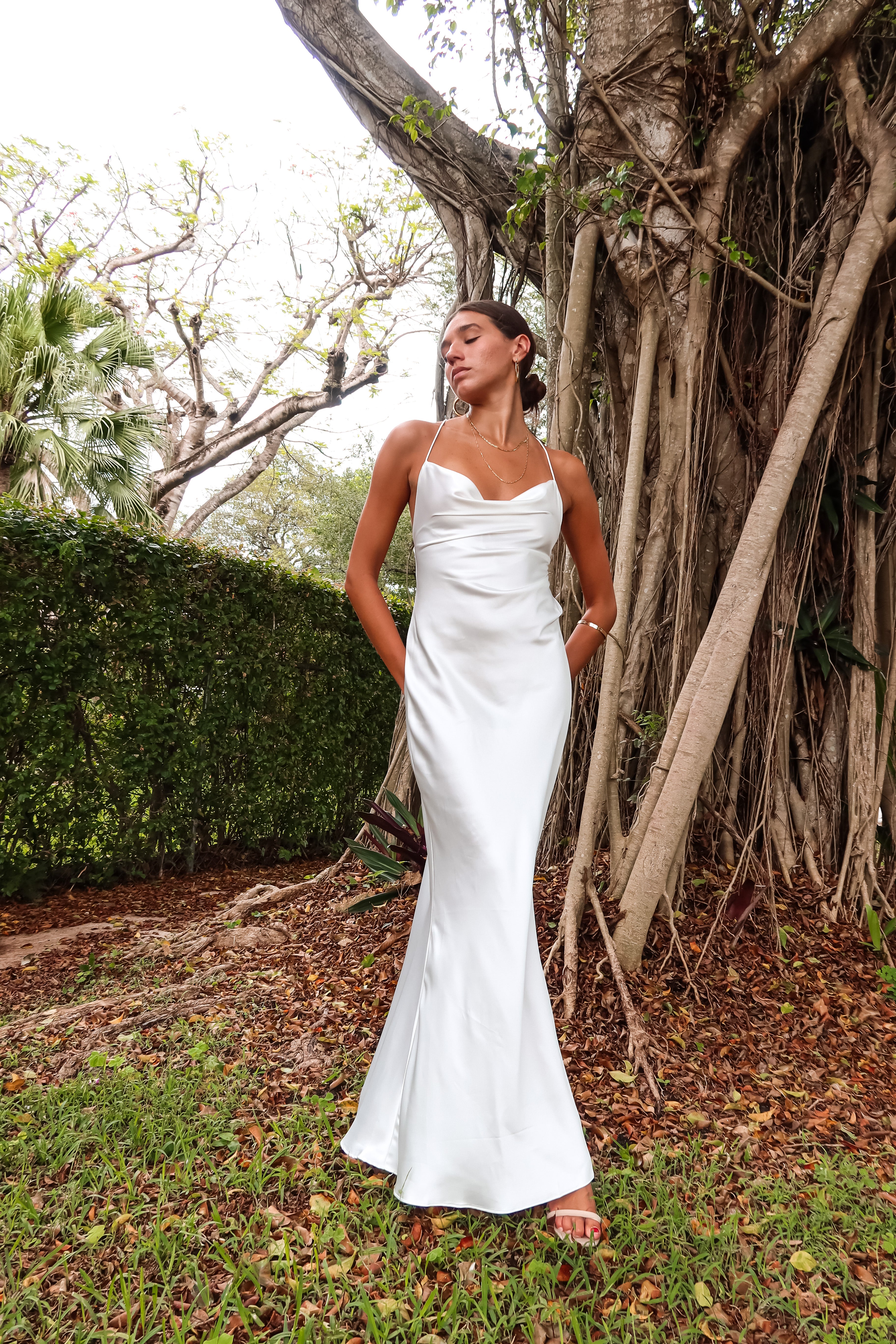 Get ready to party in our white satin maxi dress! Luxurious and thick satin fabric provides ultimate comfort and style. Adjustable string tie with gold chain detail adds a touch of glamour. Cowl neck bust and low back create a stunning silhouette. Let's get this party started!