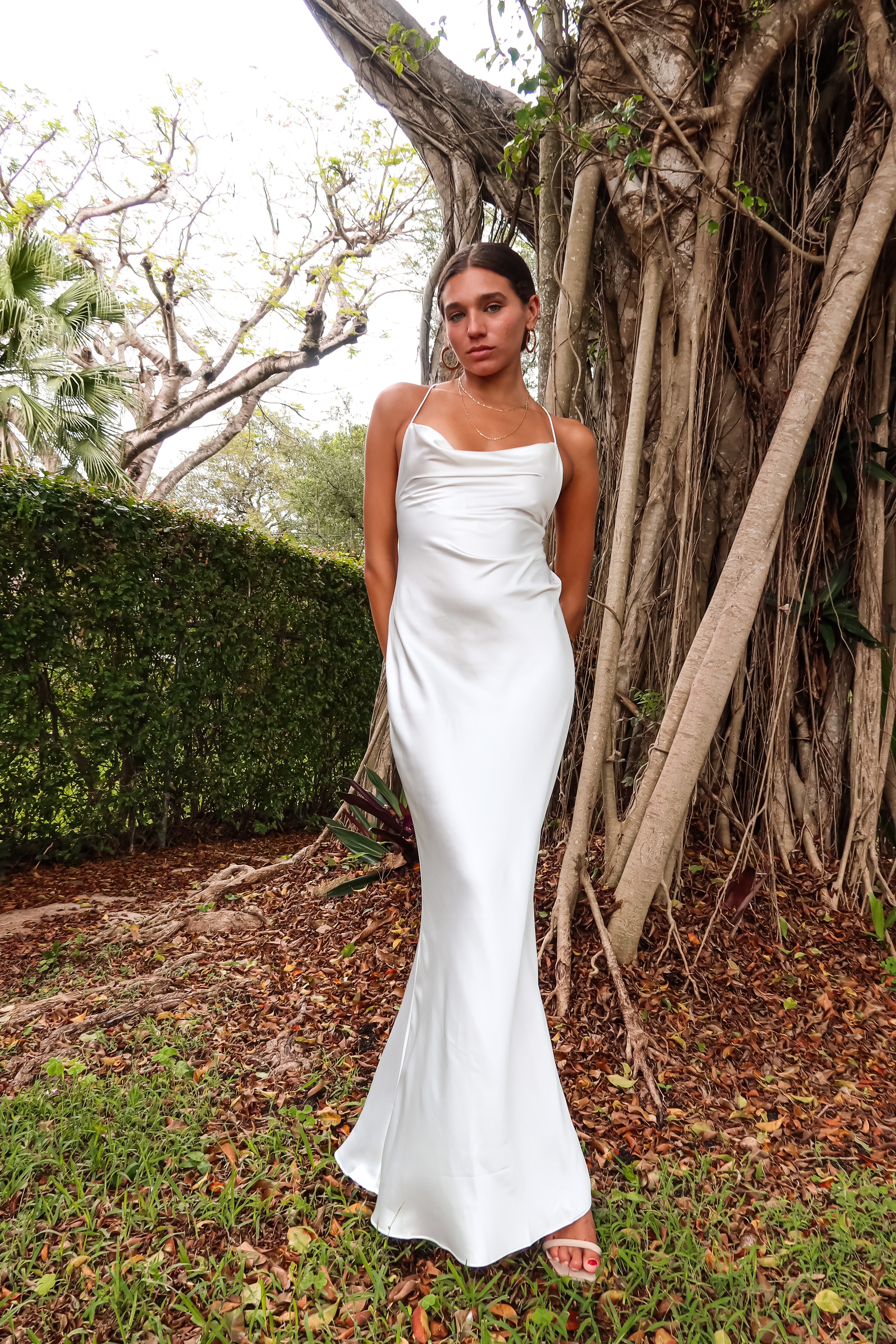 Get ready to party in our white satin maxi dress! Luxurious and thick satin fabric provides ultimate comfort and style. Adjustable string tie with gold chain detail adds a touch of glamour. Cowl neck bust and low back create a stunning silhouette. Let's get this party started!